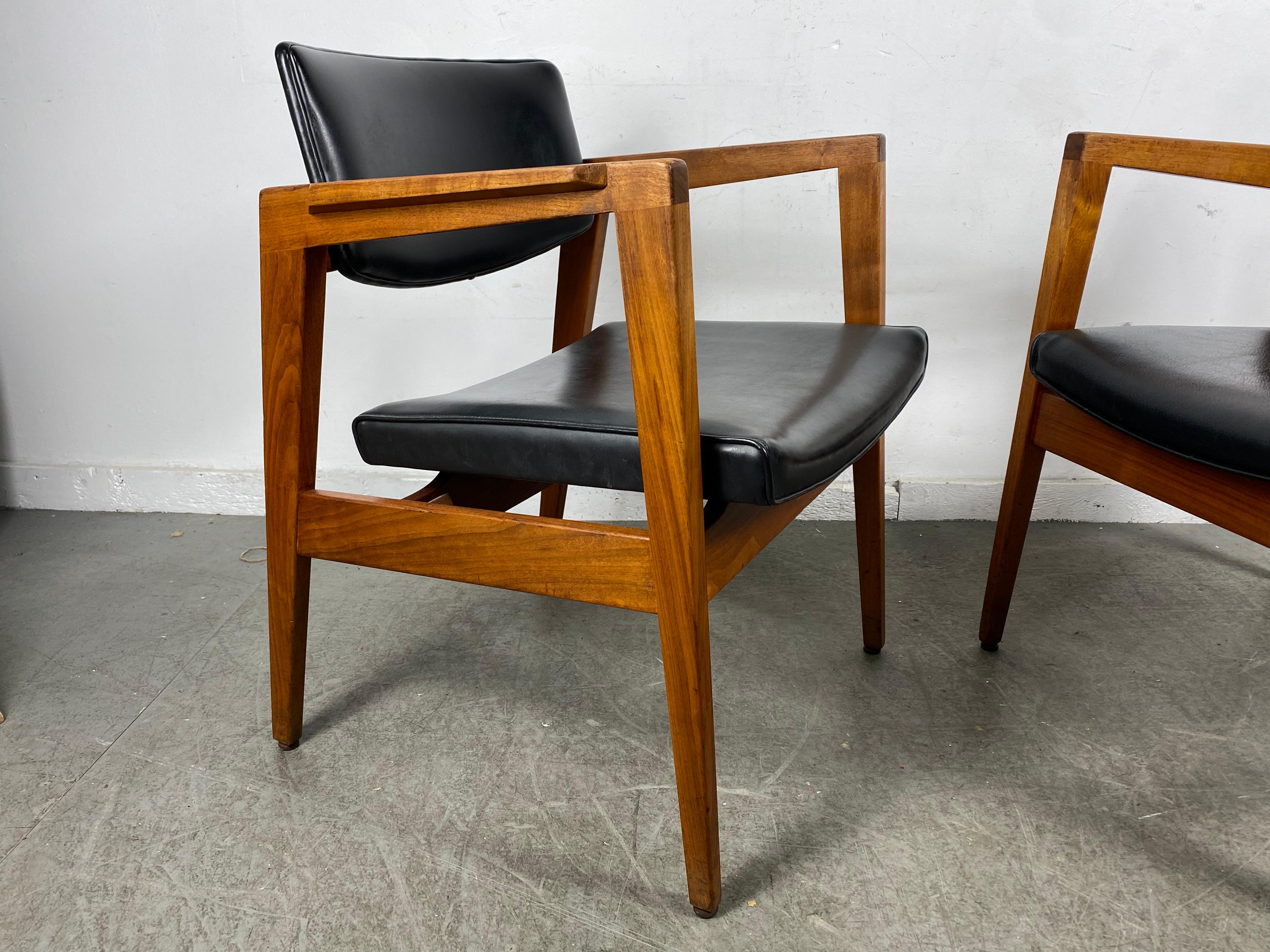 Matched Pair Classic Mid-Century Modern Lounge Chairs in solid walnut and leather manufactured by W.H.Gunlock Company. designed in the manner of Jens Risom. superior quality and construction, extremely comfortable, All original, wonderful patina.