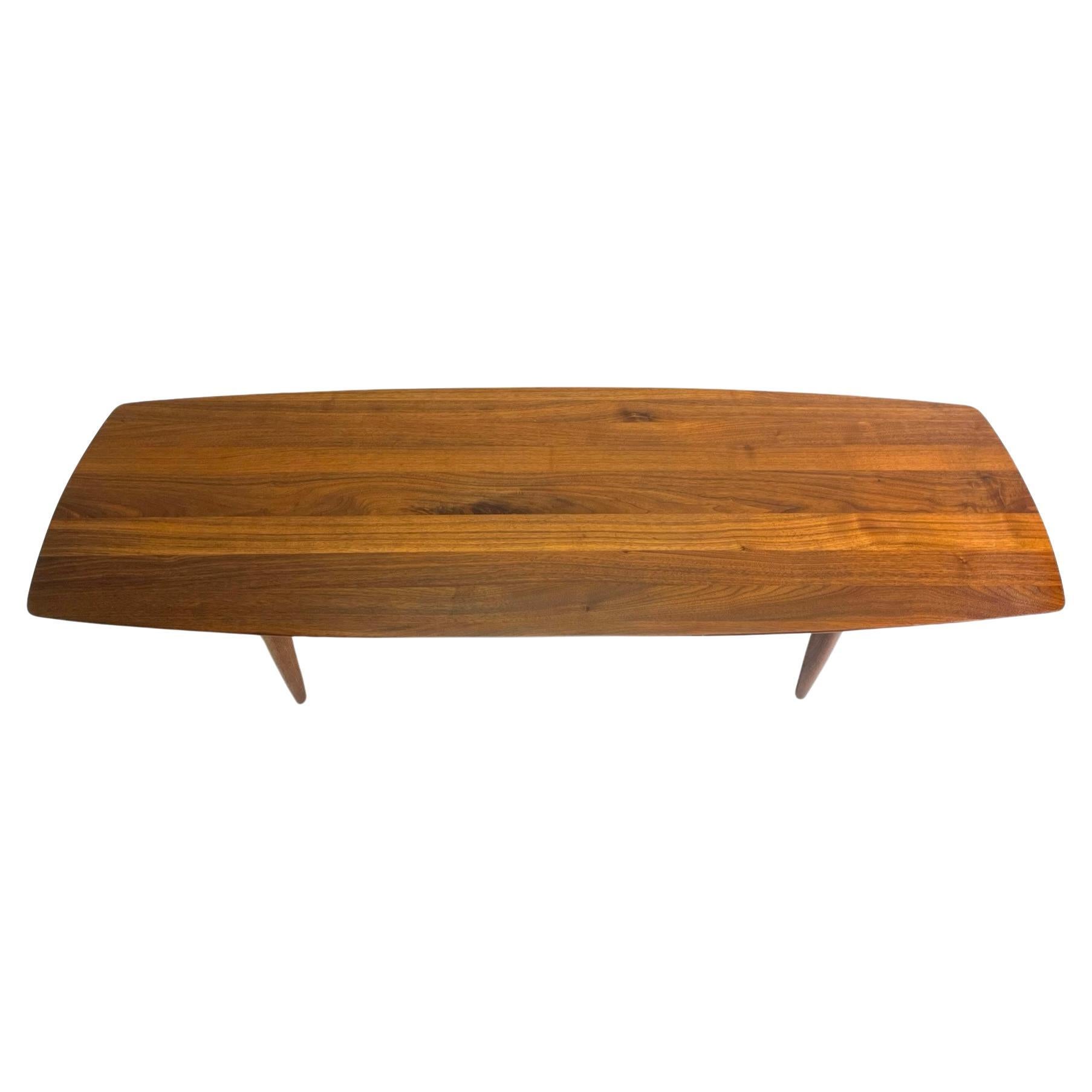 Classic mid century coffee table, made in California, by Ace-Hi as part of the Prelude line. This table is pure gorgeous wood grain, elegant shape and mid century modern magic! 
There are very few pieces of furniture made in solid wood for a couple