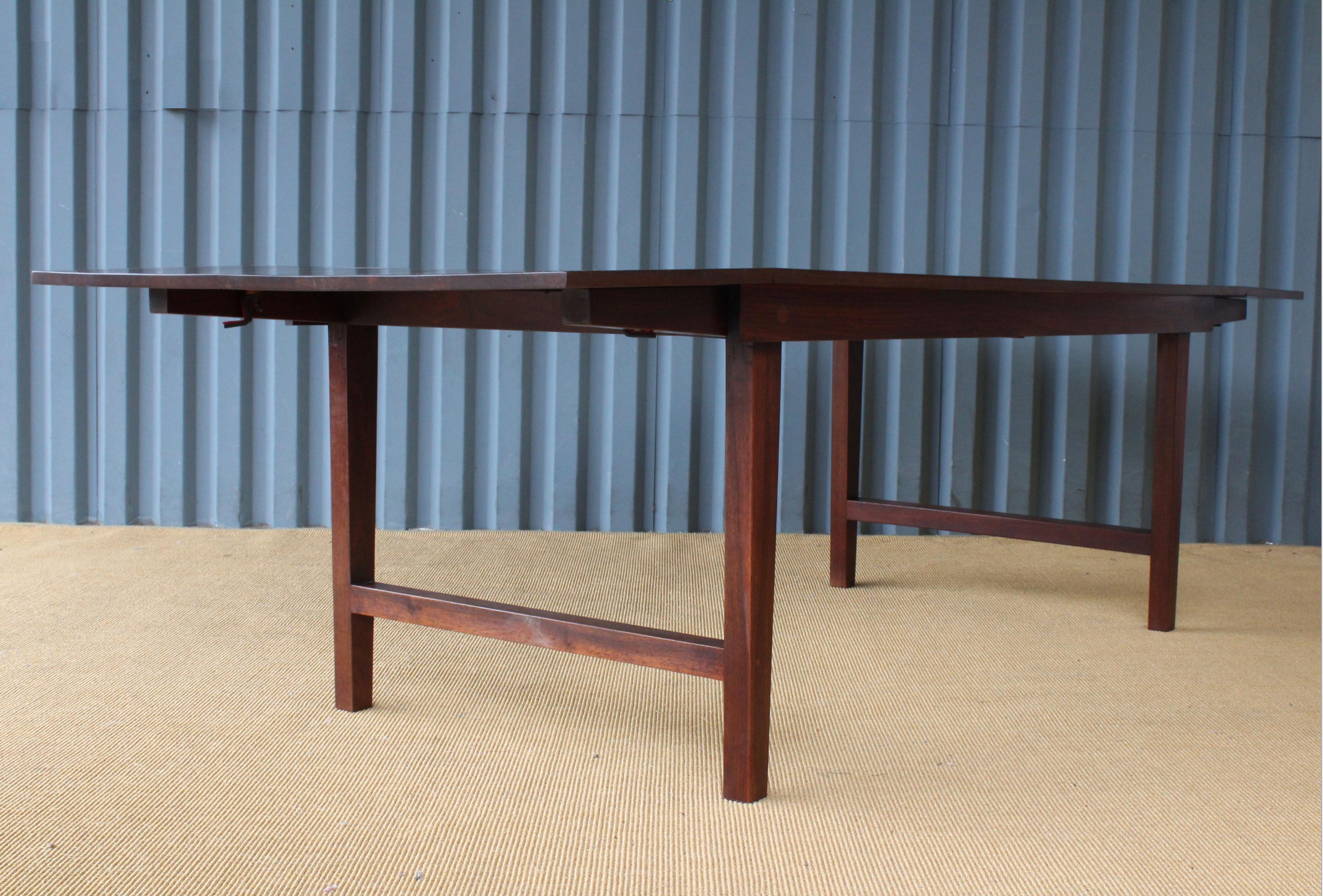 Solid walnut drop-leaf table that converts from a coffee table to a dining table. Recently refinished.