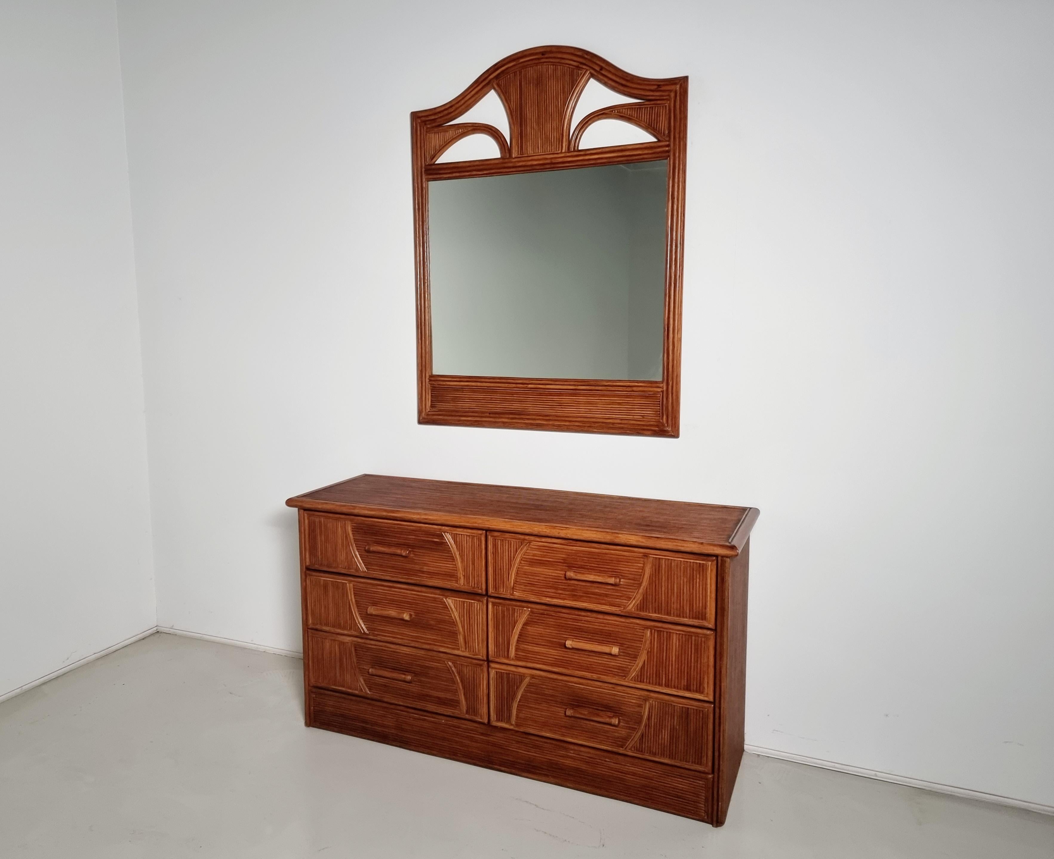 Dresser with matching mirror made of solid walnut, Italy, 1970s.

The craftsmanship of this piece is exceptional. Solid walnut has been carved on the surface with a 'grissinato' motif. Vivai del Sud style. 

Size mirror: 119cm H x 92cm W x 3cm D.
  