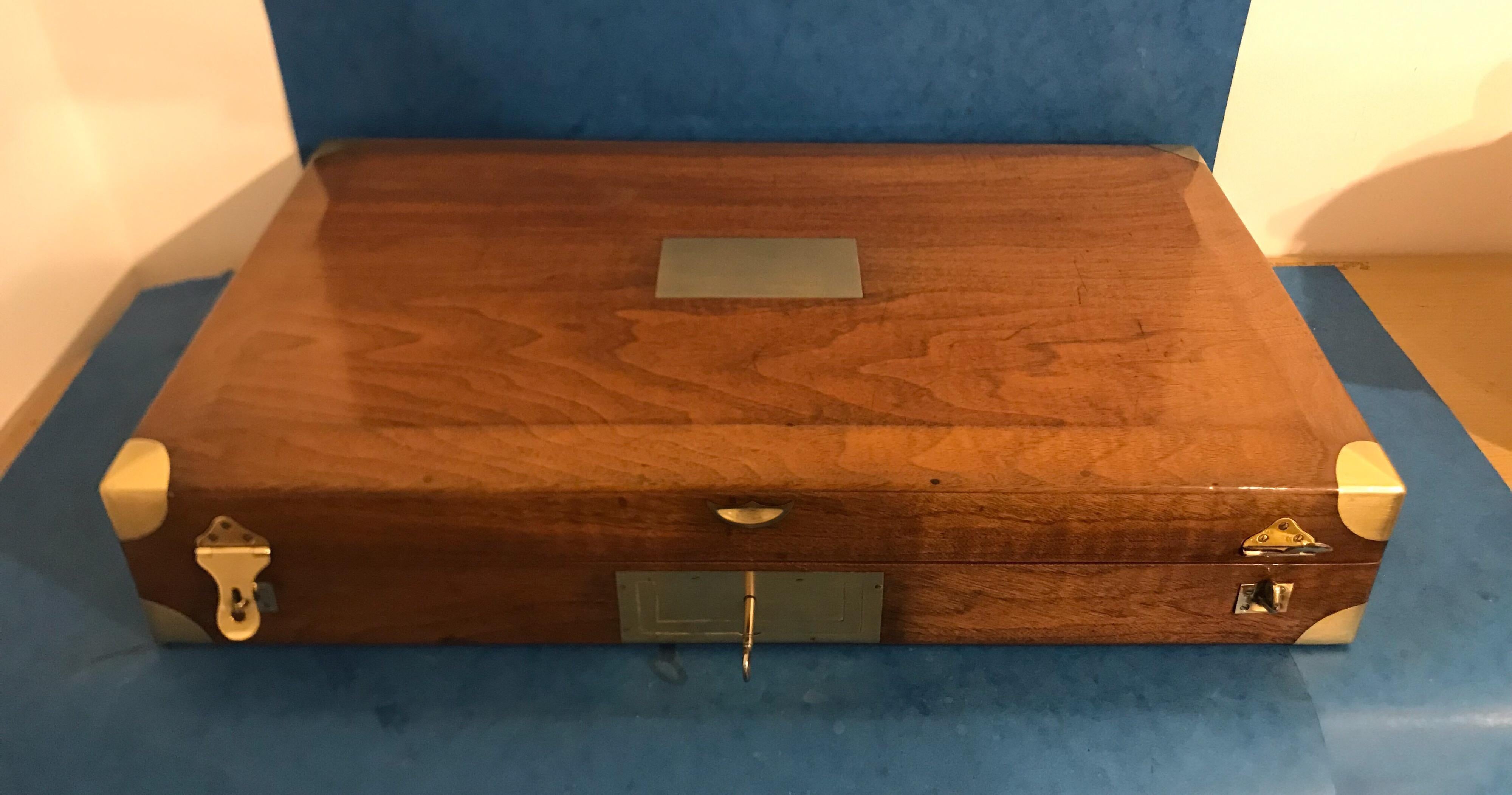 A solid walnut French probably a case for duelling pistols, it has military brass handle to the front and two locking clasps, its 19th century and dates to circa 1850, it has brass bound corners to the top of the lid, it has a relined interior,