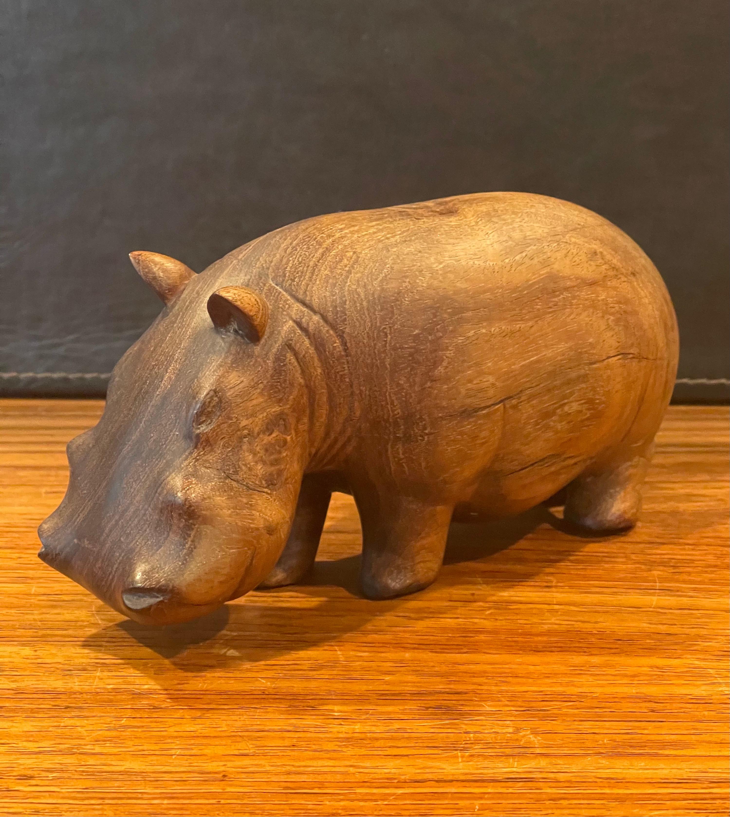 A very nice solid walnut hand carved figural hippopotamus sculpture, circa 1980s. The piece is in very good condition and measures 8.5