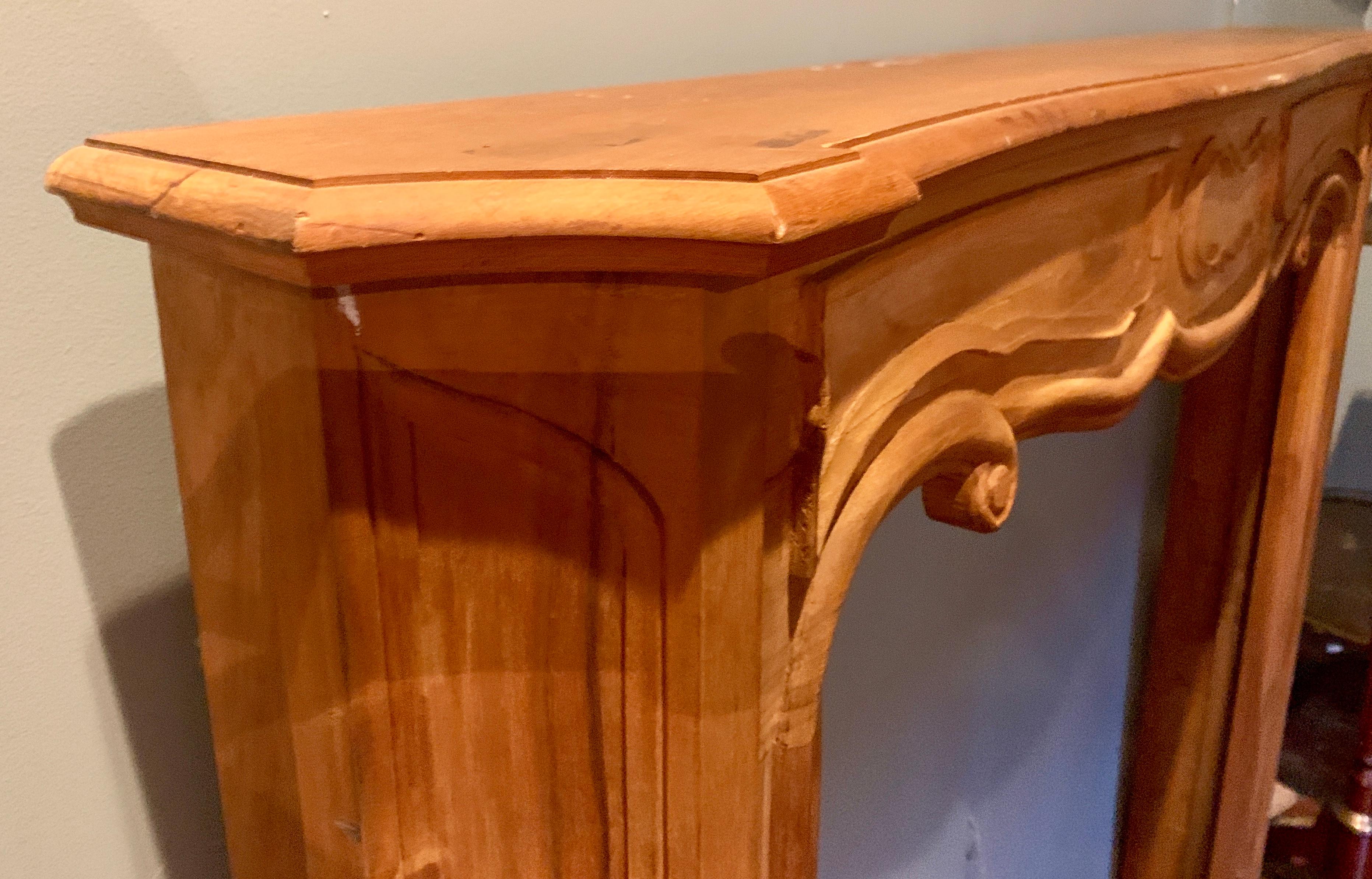 This hand-carved mantel has simple, strong lines. It would work well in a variety of homes. The walnut is a lovely color, too.

