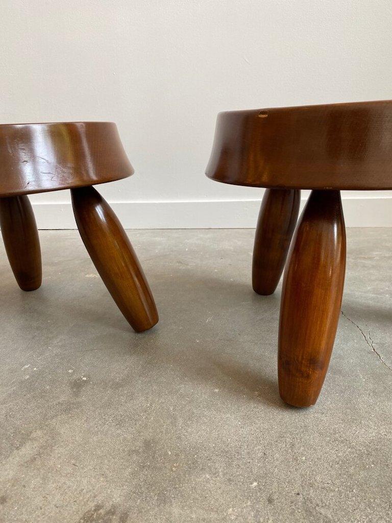 A pair of solid walnut and hand carved stools in the manner of Jean Royere. The pair boasts rounded legs and a beveled top all the while being solid, heavy and beautifully crafted. Price is per stool. $1,950 per stool/ $3,500 for the pair.

 