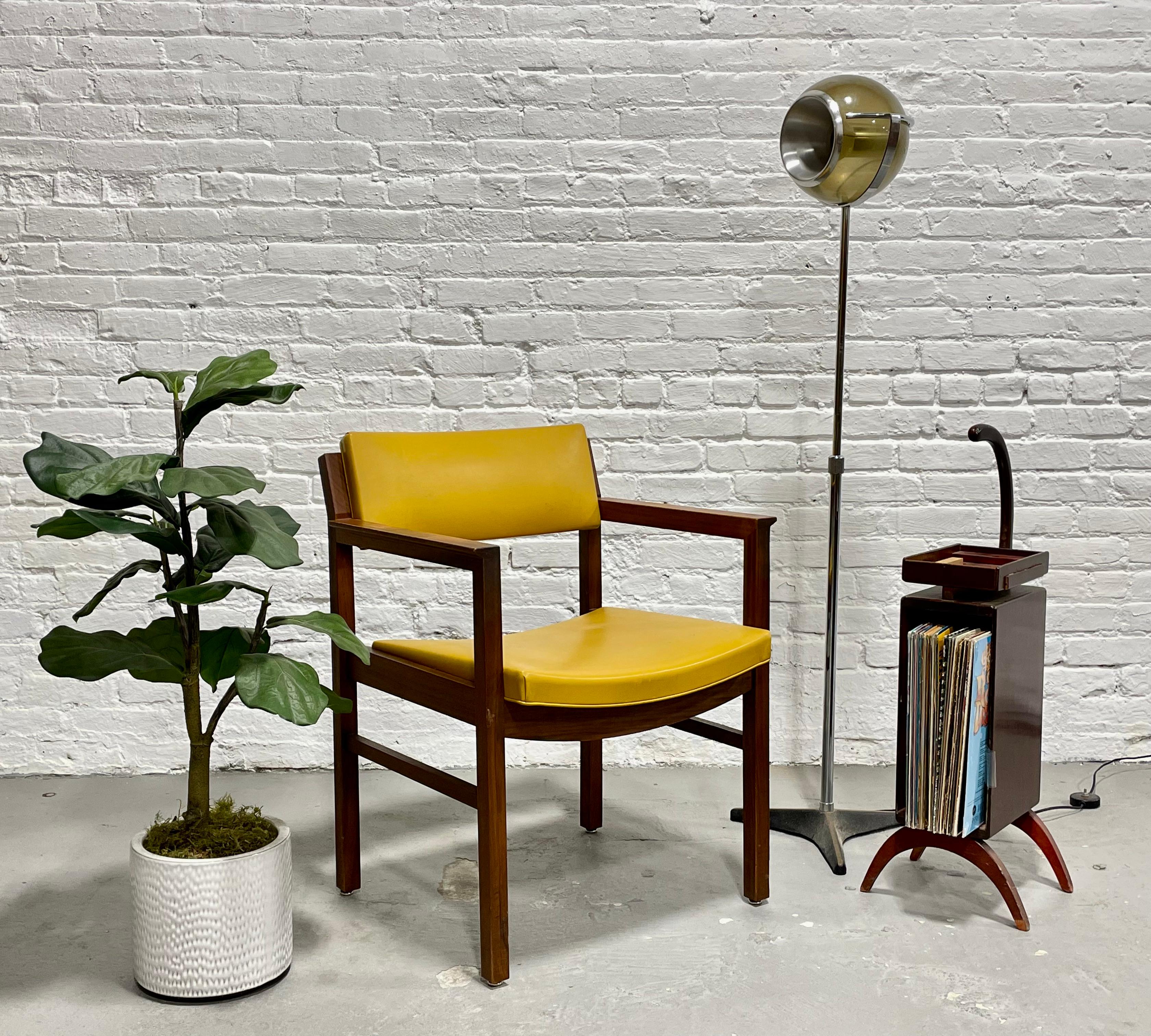 Walnut Mid-Century Modern Armchair by Ebena LaSalle of Montreal, circa 1960s. Well made from solid walnut contrasted with a pineapple yellow vinyl upholstery. Simple, modern design with flared arm rests and as lovely from the back as it is from the