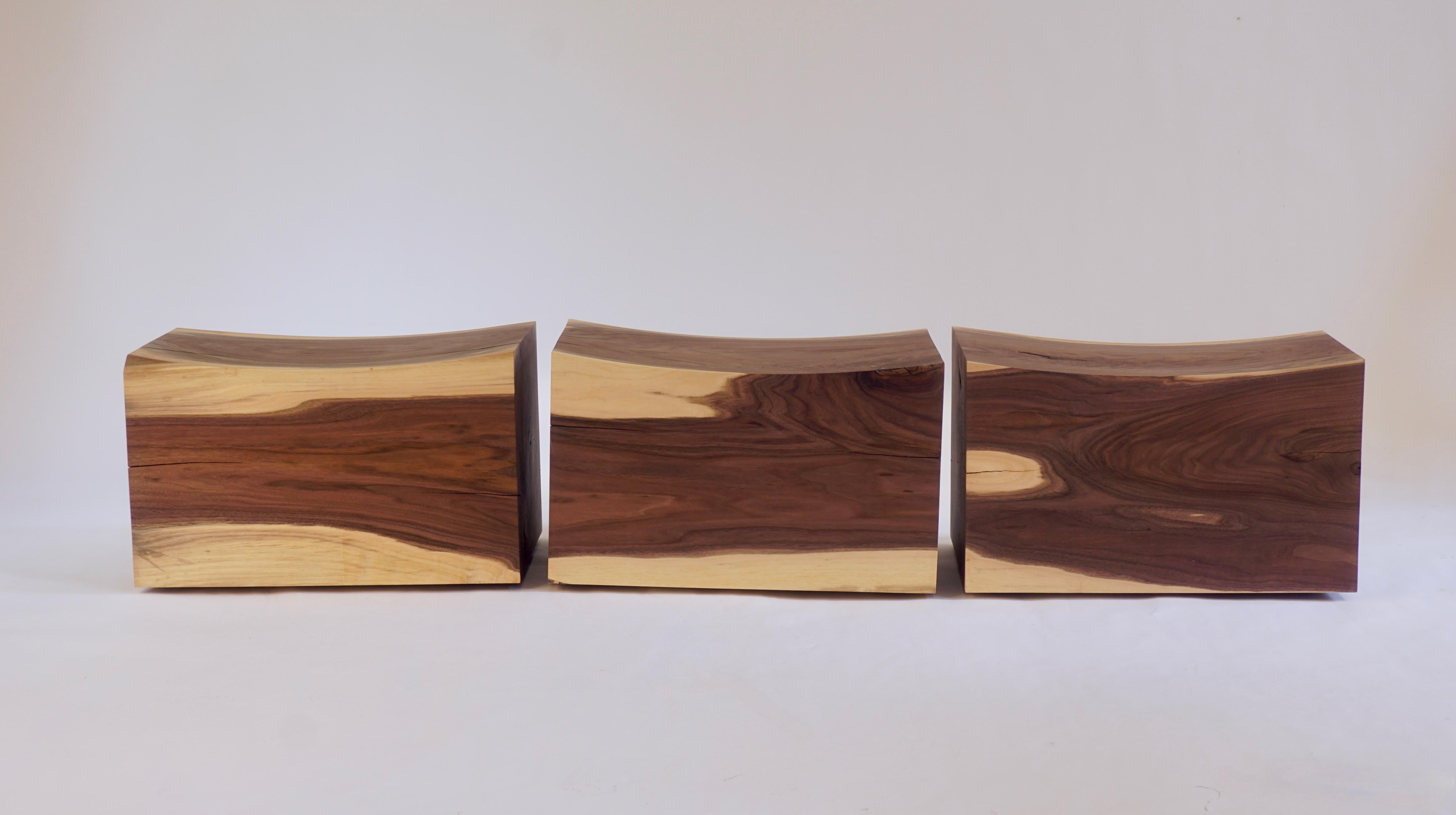 These walnut pillow pedestals - benches - were made from solid walnut logs sourced locally near the Chris Lehrecke studio in upstate New York. After being hand carved and sanded they are given an oil finish. Four very high quality spherical casters