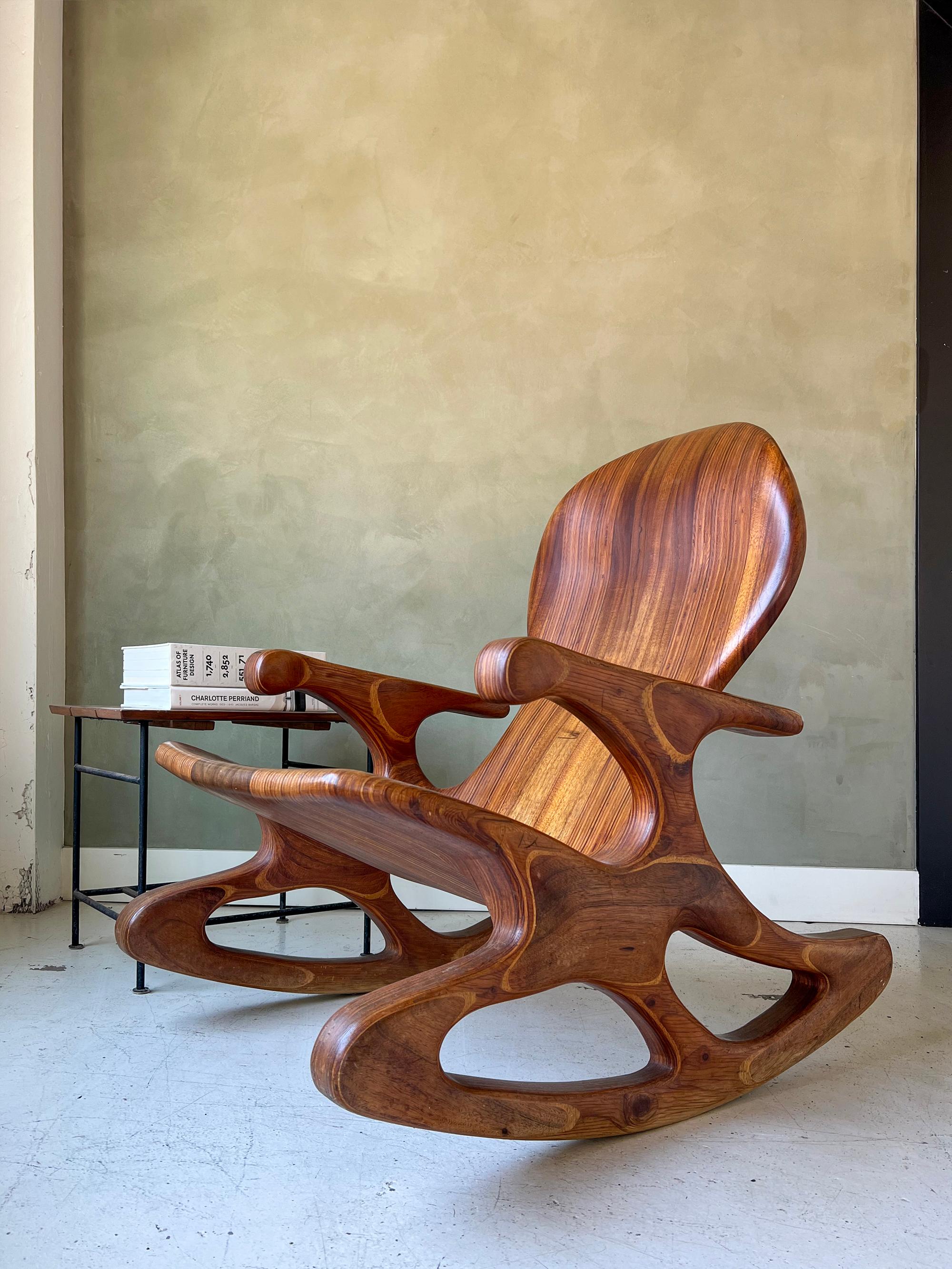 Vintage hand-sculpted rocking chair. Solid walnut core with laminated walnut plywood for the sides and base. Incredibly solid chair with ergonomic backrest and seat. One-of-a-kind and signed by 