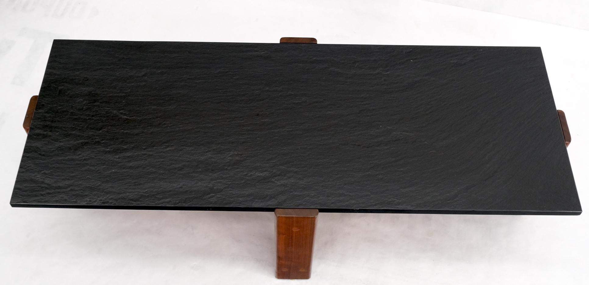 High quality craftsmanship slate top solid oiled walnut base coffee table signed and dated 1972.