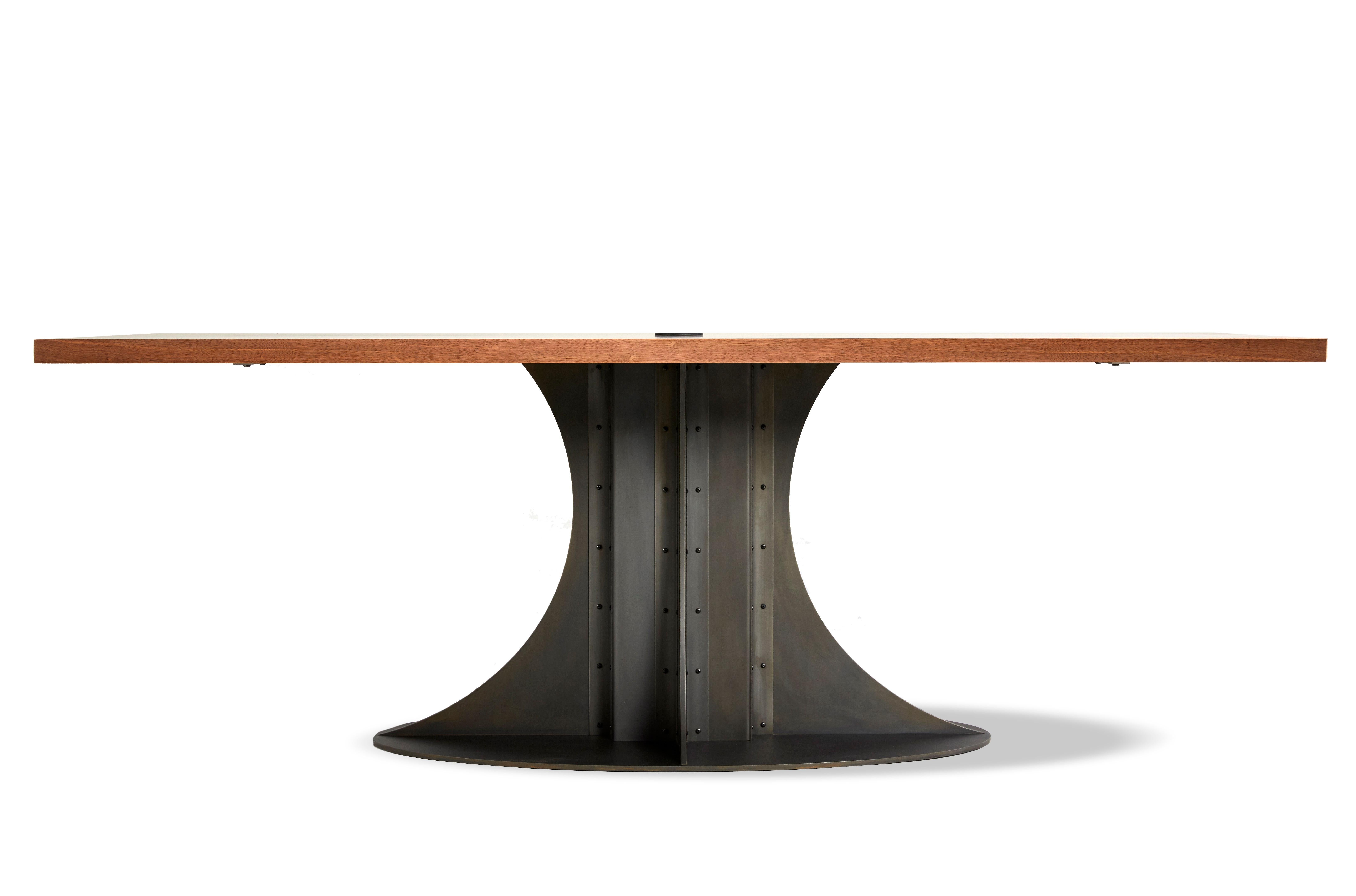 The Empire pedestal table is a powerful addition to the Mark Jupiter Elegant Industrial collection. With a massive center pedestal inspired by the spire cap of the Empire State Building this solid Walnut and blackened steel table will not only be a