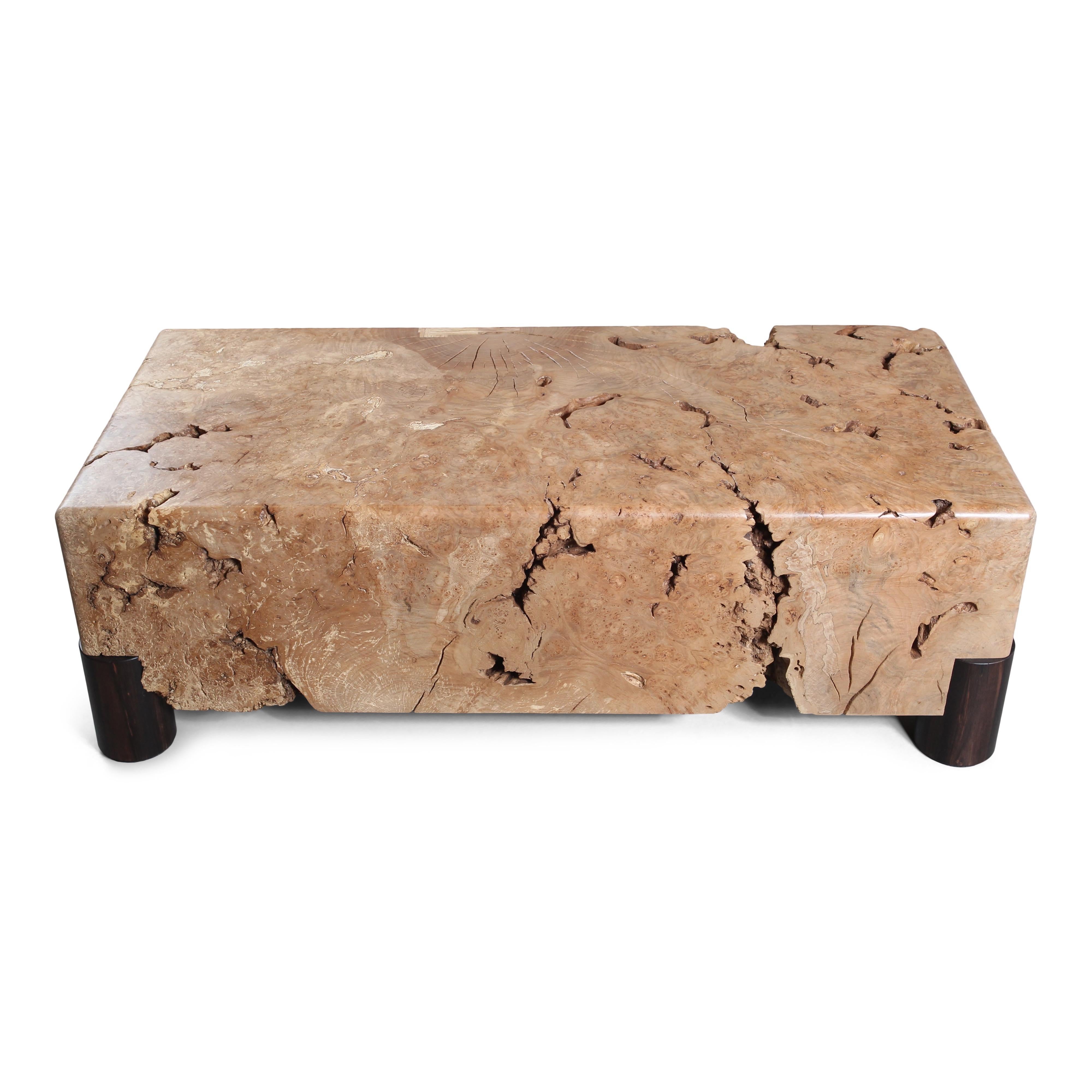 A solid chunk of figured Western Maple burl meticulously sculpted to a level that allows it to serve as a functional table while maintaining its organic feel. Hand-turned Macassar Ebony legs support the table on each corner.

The burl itself has