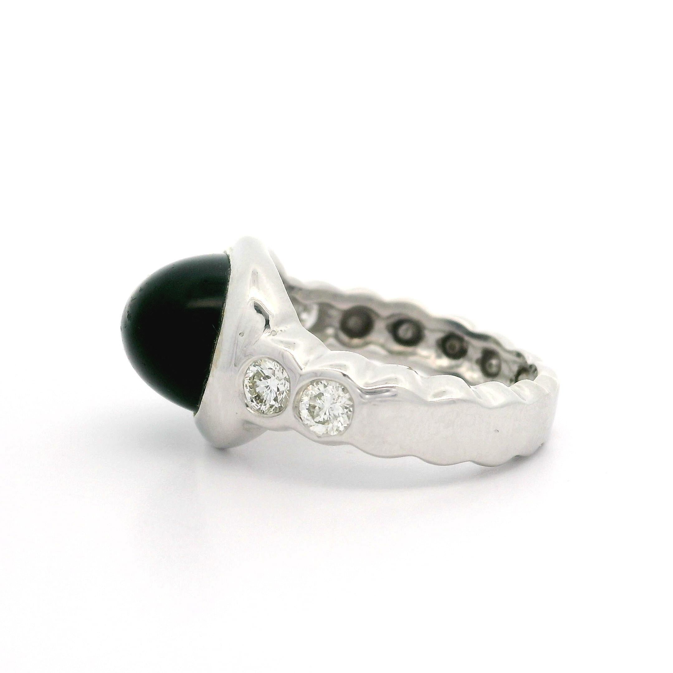 –Stone(s): –
(1) Natural Genuine Onyx - Oval Cabochon - Bezel Set - Black Color - 11.62 x 9.12mm (approx.)
(4) Natural Genuine Diamonds - Round Brilliant - Bezel Set - I Color - SI2 Clarity - 0.40ctw (approx.)

Material:  18k White Gold
Total