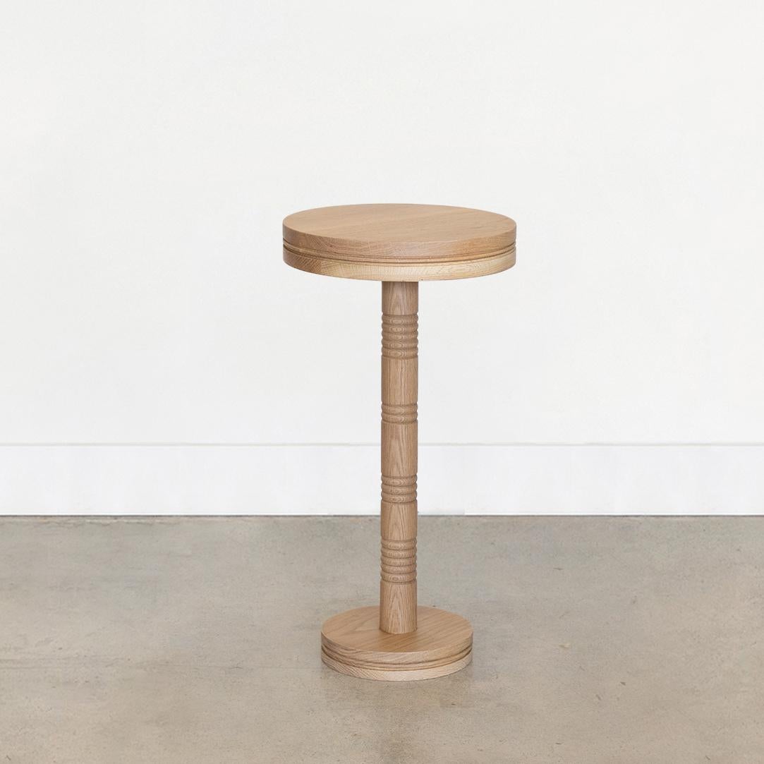 Newly made solid white oak drink table with carved ribbed detailing on stem. Circular top and circular base. Made in Los Angeles. Multiple quantity and custom sizes available.