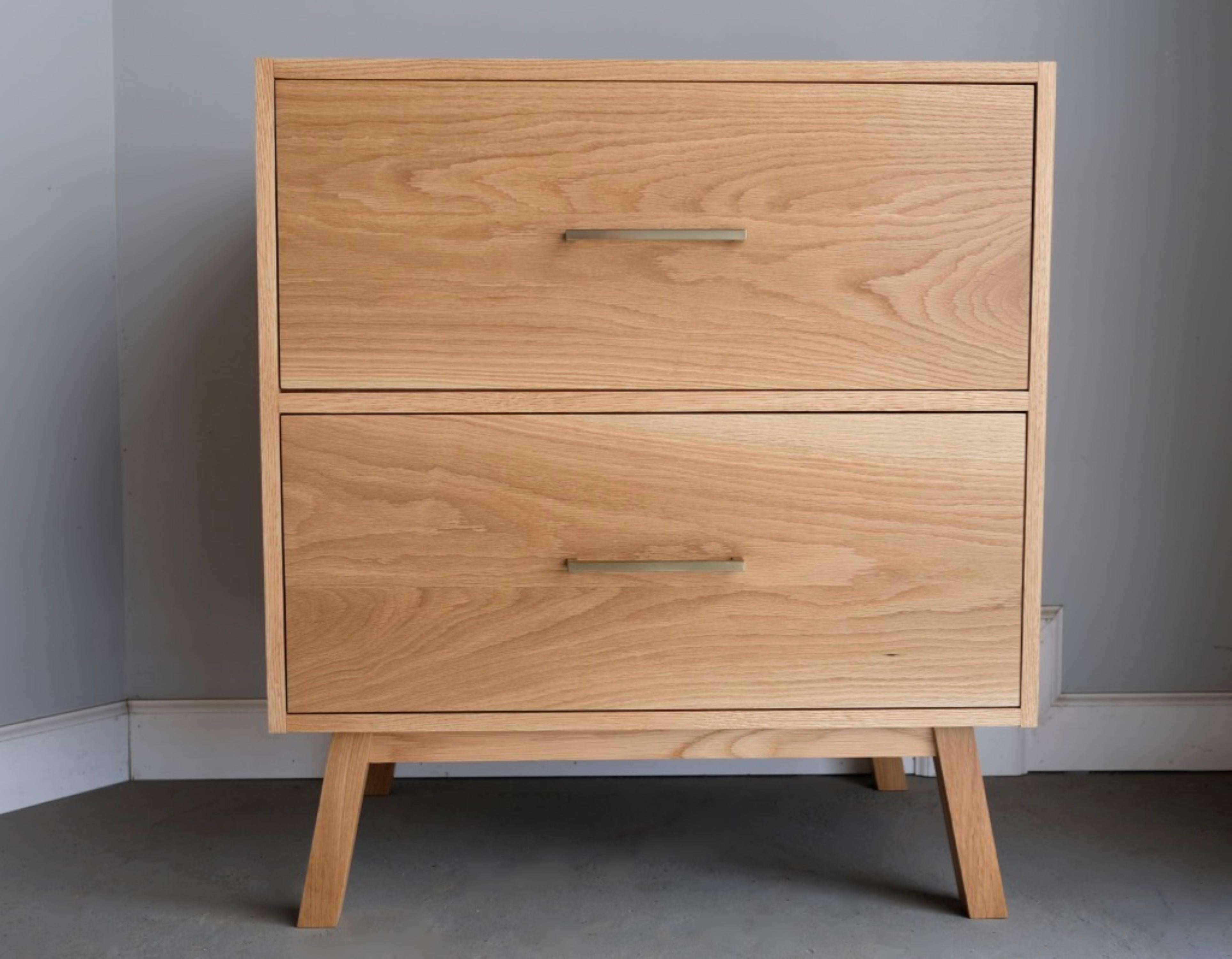 This nightstand features a solid hardwood case with a minimal modern perimeter and two inset drawers. Handcrafted in our shop from locally sourced materials with traditional craftsmanship. The drawers are dovetailed with soft close blum slides and