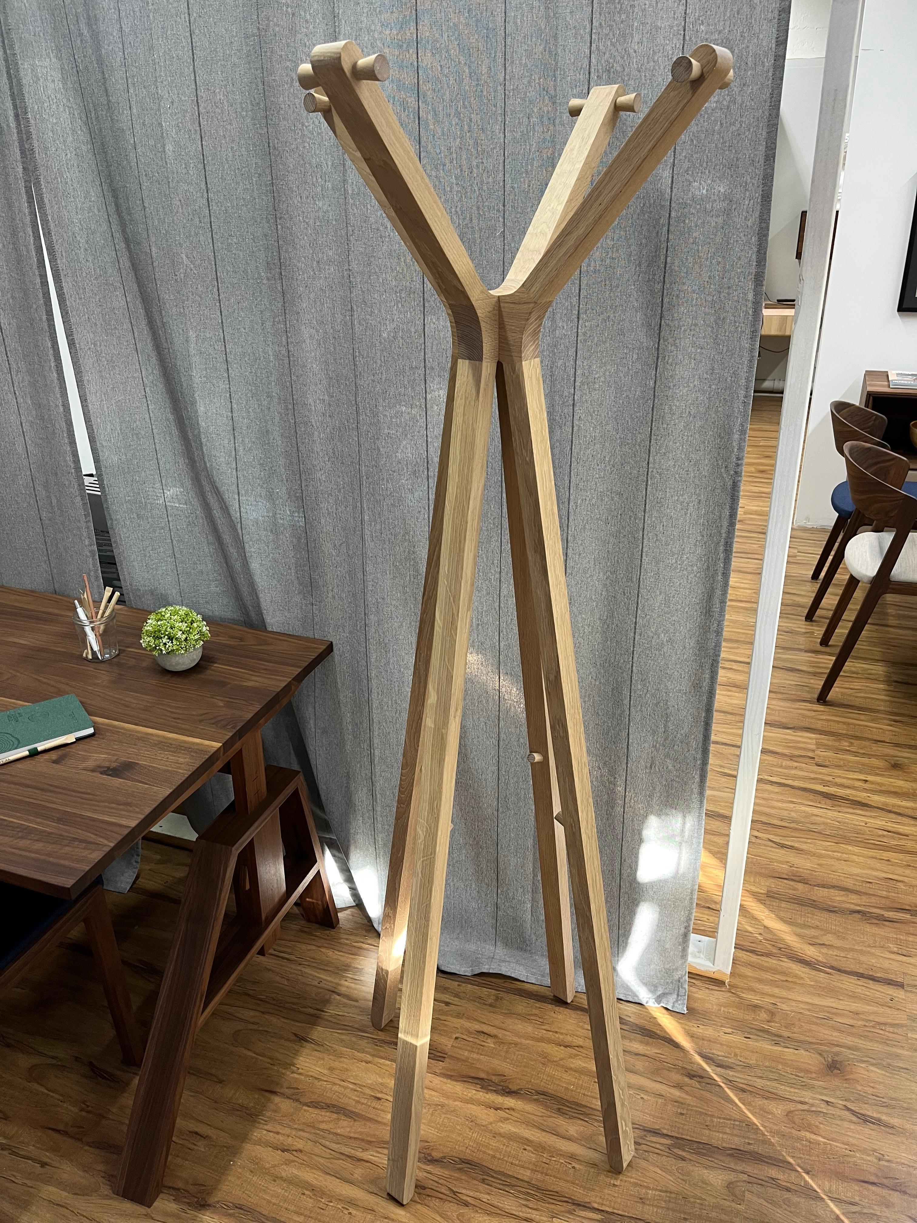 The craftsmanship of this solid wood coat tree sets it apart from all other designs. The slender solid wood frame and the interplay of angular and rounded shapes makes this coat rack a versatile piece designed for an entry hall. While this coat rack