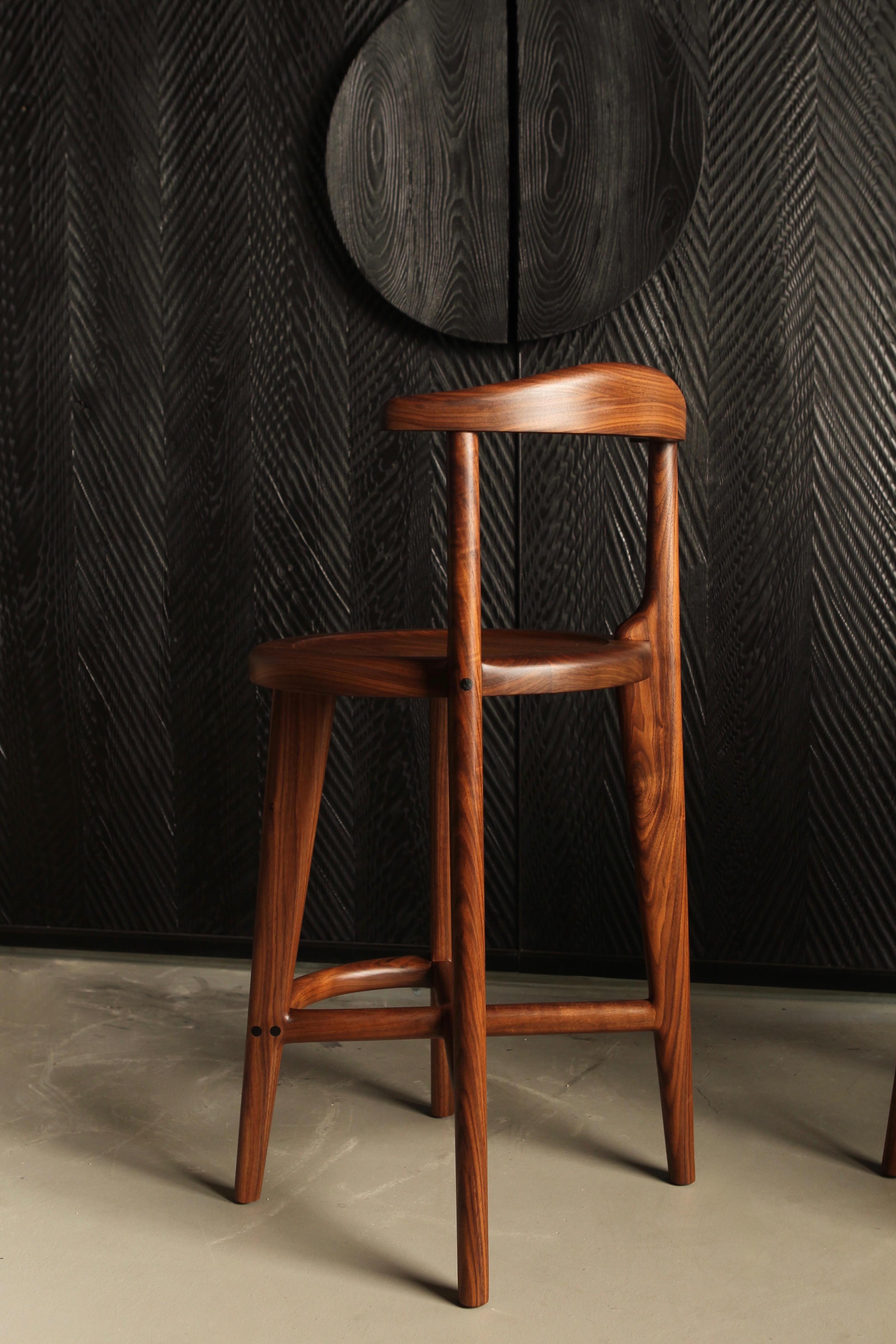 A classic design that will beautifully suit any home interior. Crafted from solid American black walnut, wood is hand-selected for color uniformity and quality. Our stools feature generously sized seats and ergonomically sculpted back / arm