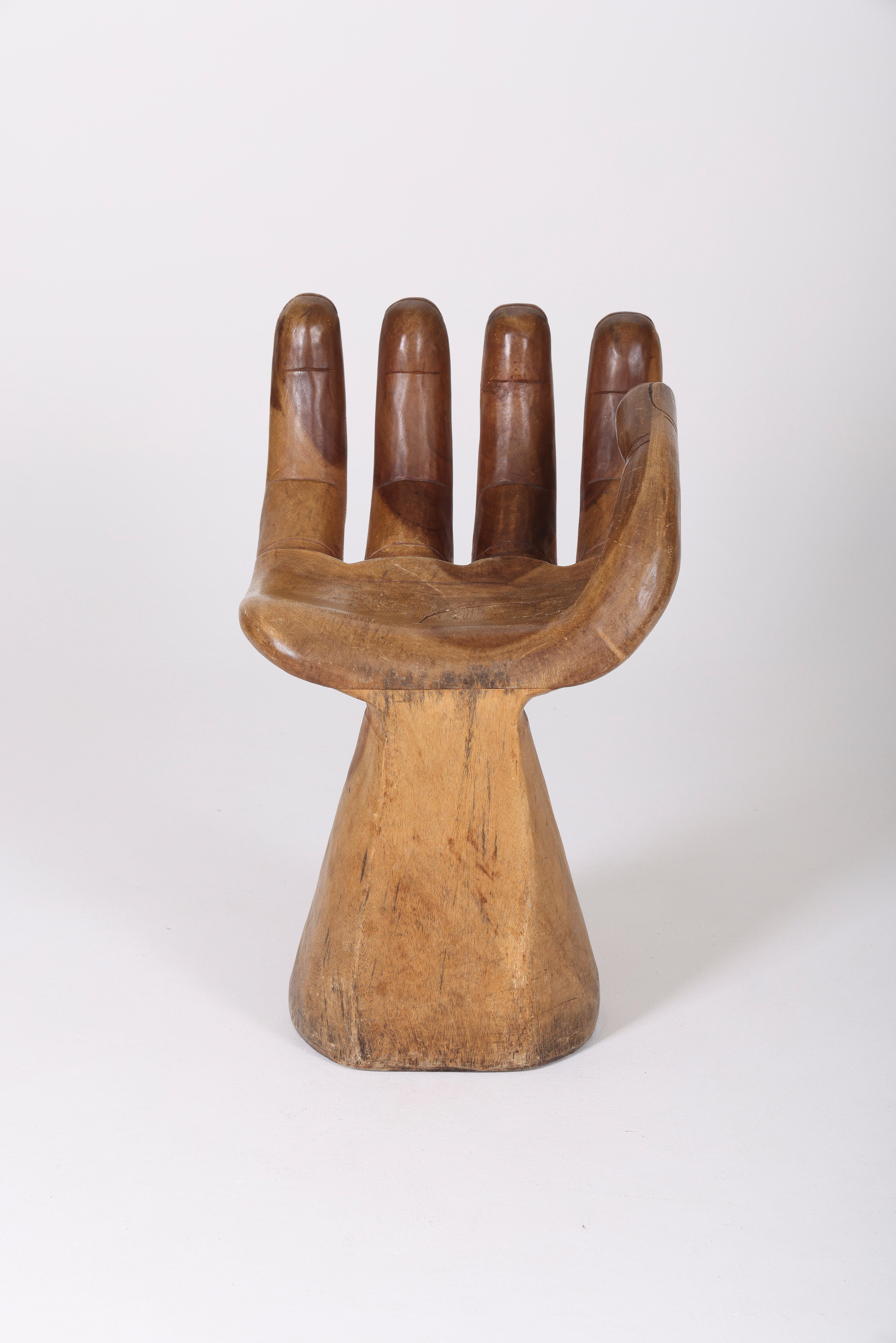 Solid wooden chair carved in the shape of a hand from the 1960s. No apparent signature, in the style of 