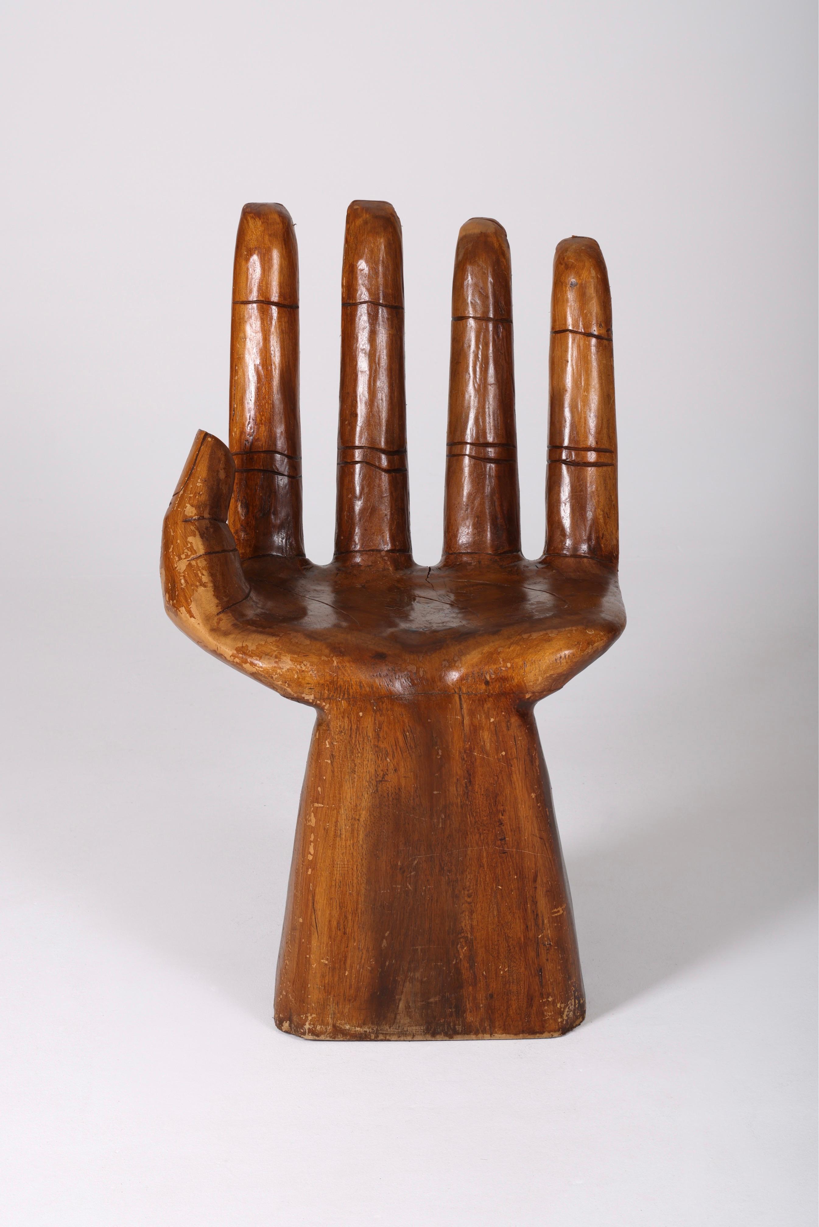 Solid wooden chair carved in the shape of a hand from the 60s. No apparent signature, in the style of 