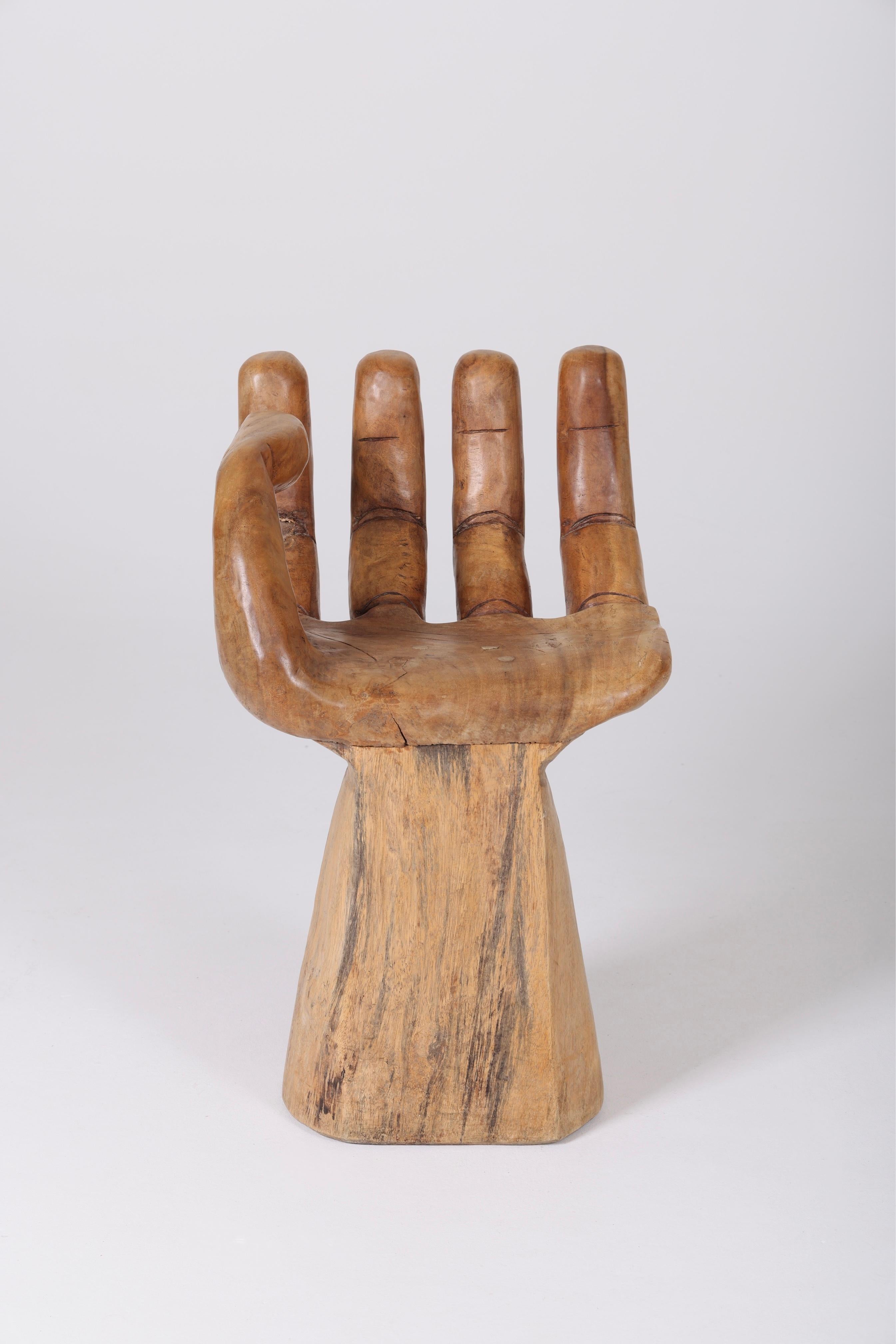 Solid wooden chair carved in the shape of a hand from the 1960s. No apparent signature, in the style of 