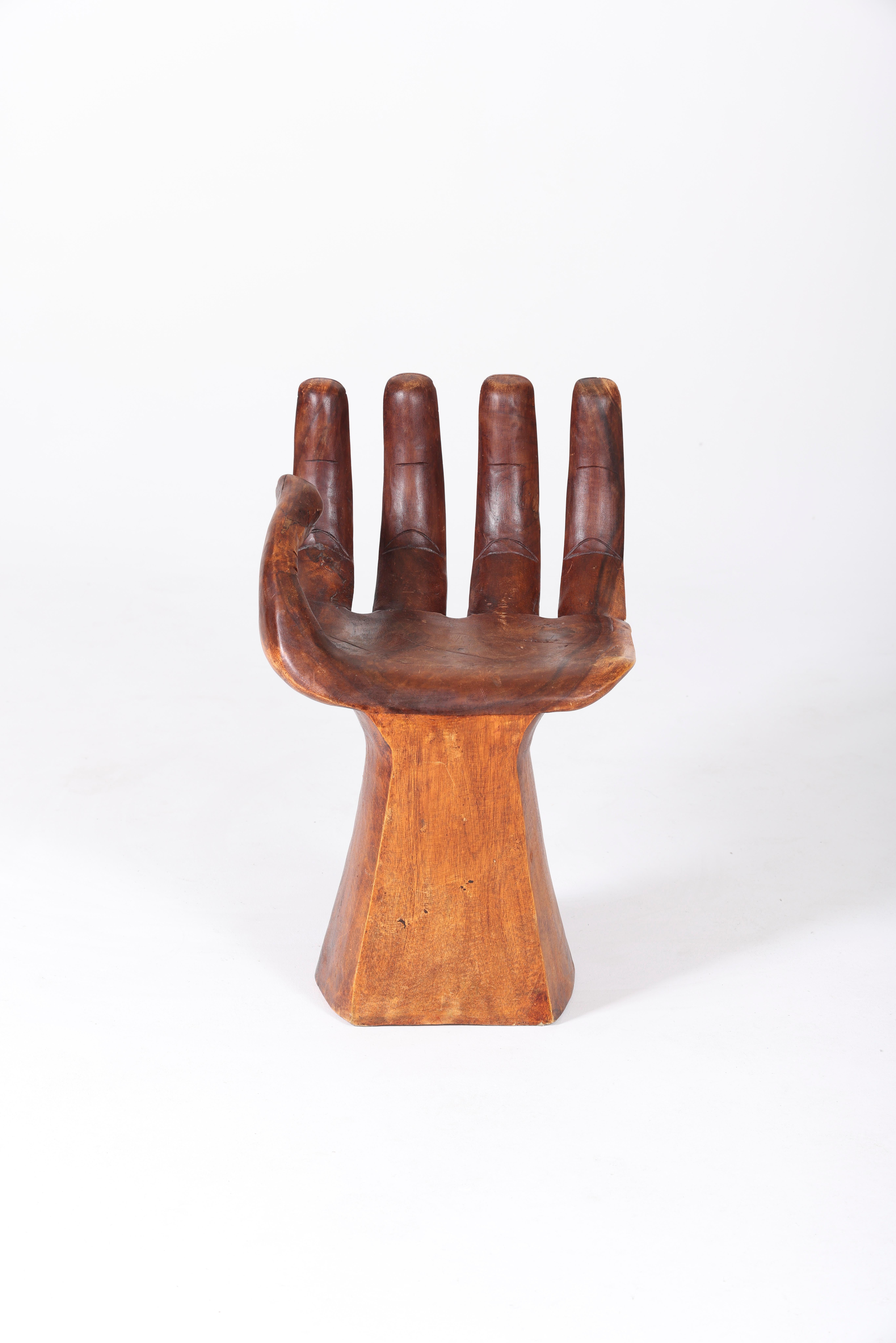 Solid wooden chair carved in the shape of a hand from the 60s. No apparent signature, in the style of 