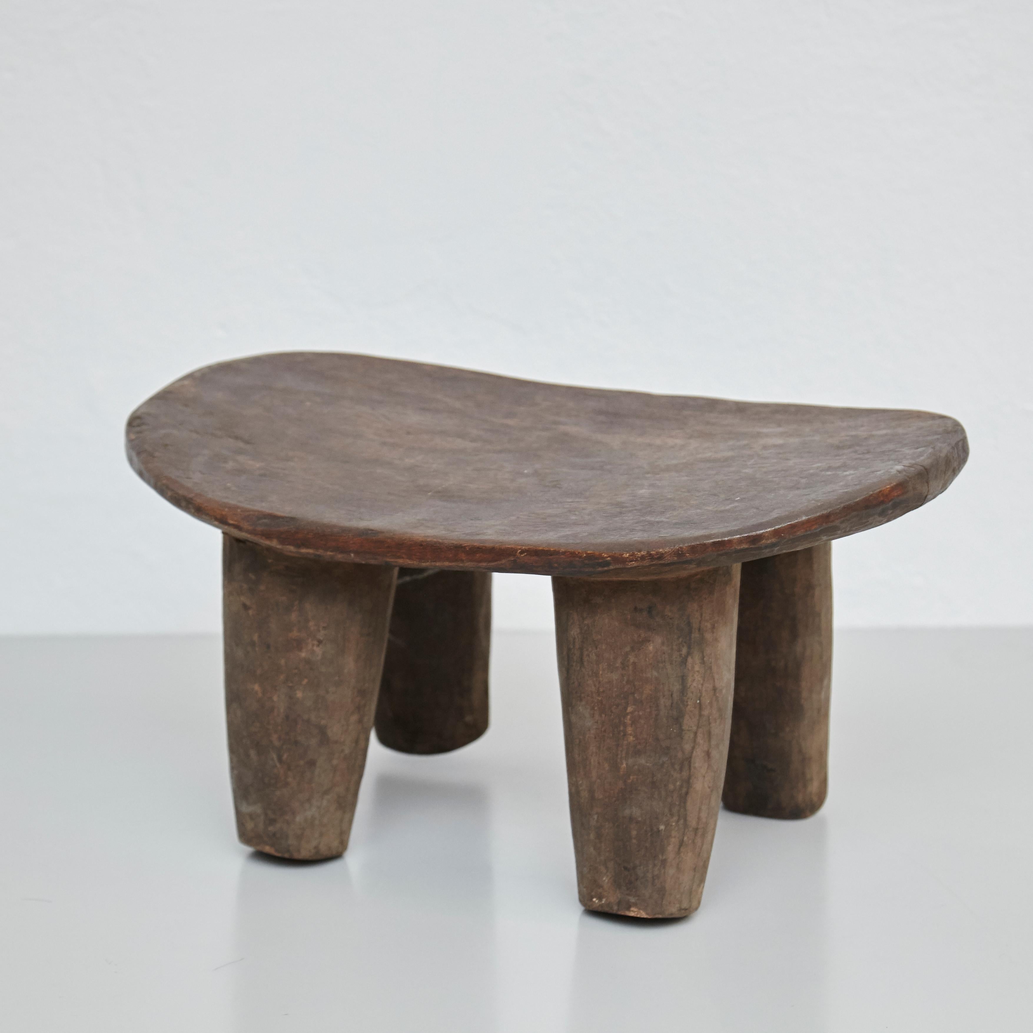 Solid wood handmade African stool.
By unknown artisan, Africa, circa 1950.

In original condition, with minor wear consistent with age and use, preserving a beautiful patina.

Materials:
Wood

Dimensions:
D 27 cm x W 46.5 cm x H 24 cm.