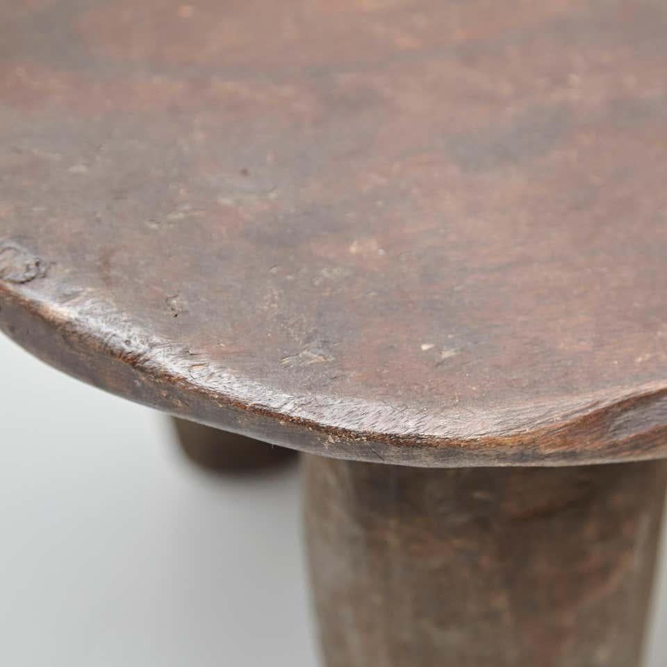 Solid wood handmade African stool.
By unknown artisan, Africa, circa 1950.

In original condition, with minor wear consistent with age and use, preserving a beautiful patina.

Materials:
Wood

Dimensions:
D 27 cm x W 46.5 cm x H 24 cm.