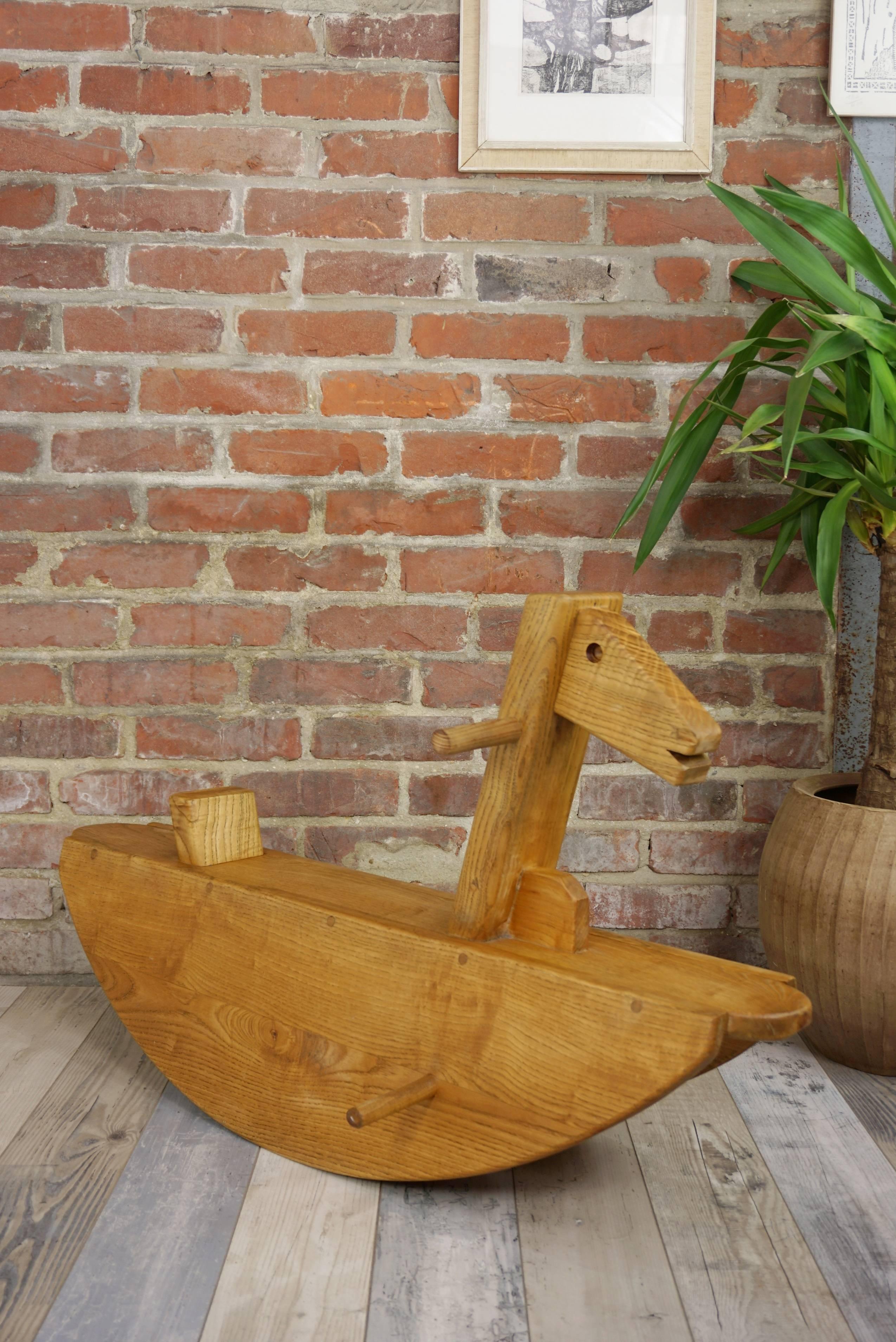 Adorable wooden old rocking horse made in France.