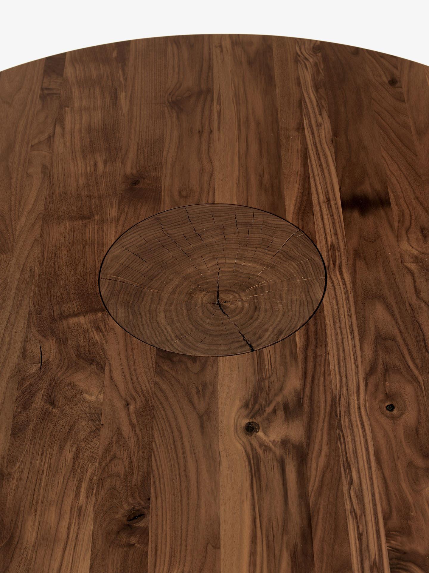 This table celebrates the raw beauty of natural wood with a striking design.  The tabletop, crafted from glued lists of solid wood, offers a smooth and durable surface.  Its most distinctive feature is the single, robust leg—a section of a tree
