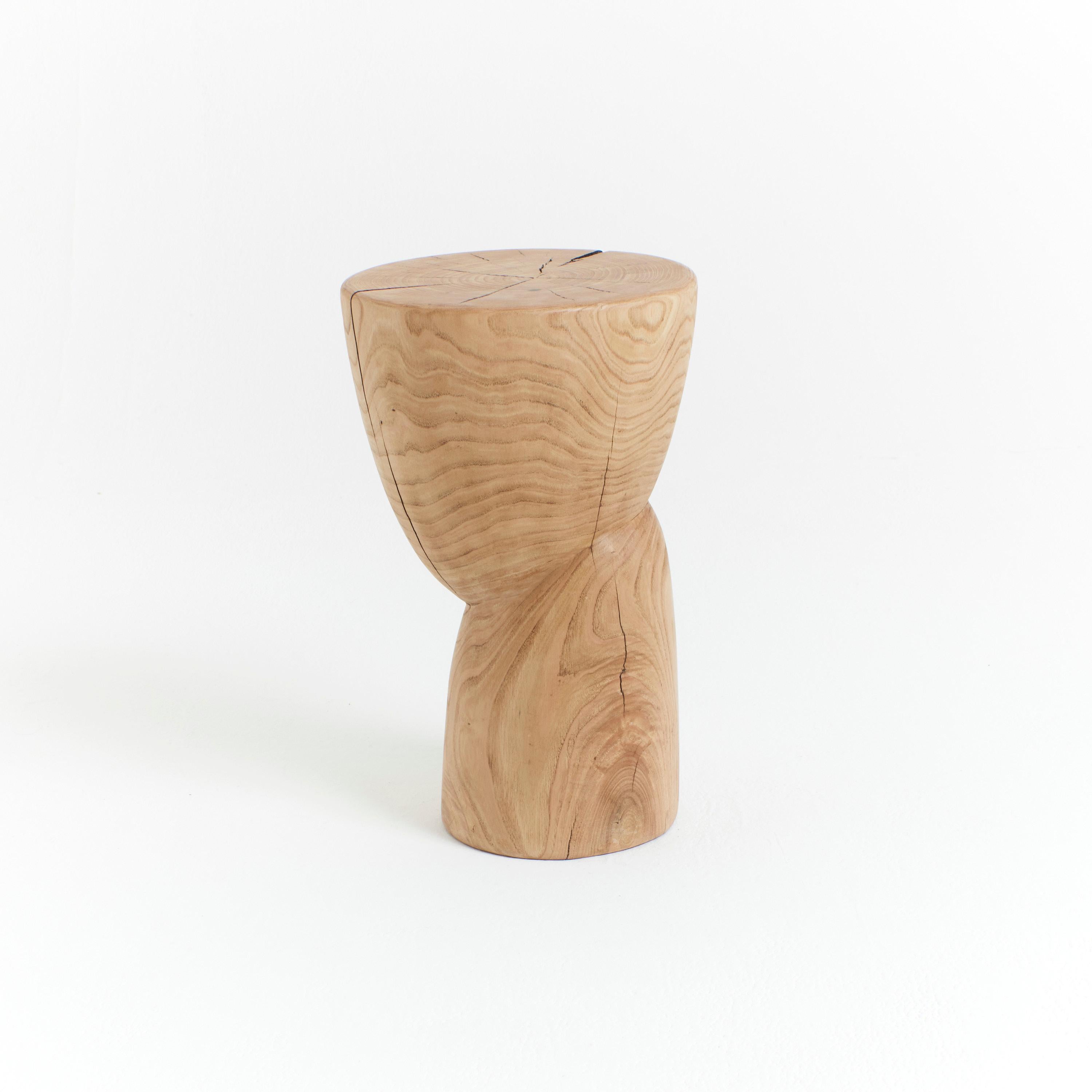 Wooden side table in natural textured wood.
Designed by Project 213A in 2020 
This sculptural side table is hand carved by local artisans in Portugal using solid chestnut which shows the natural grain and characteristics of the wood.
Available in