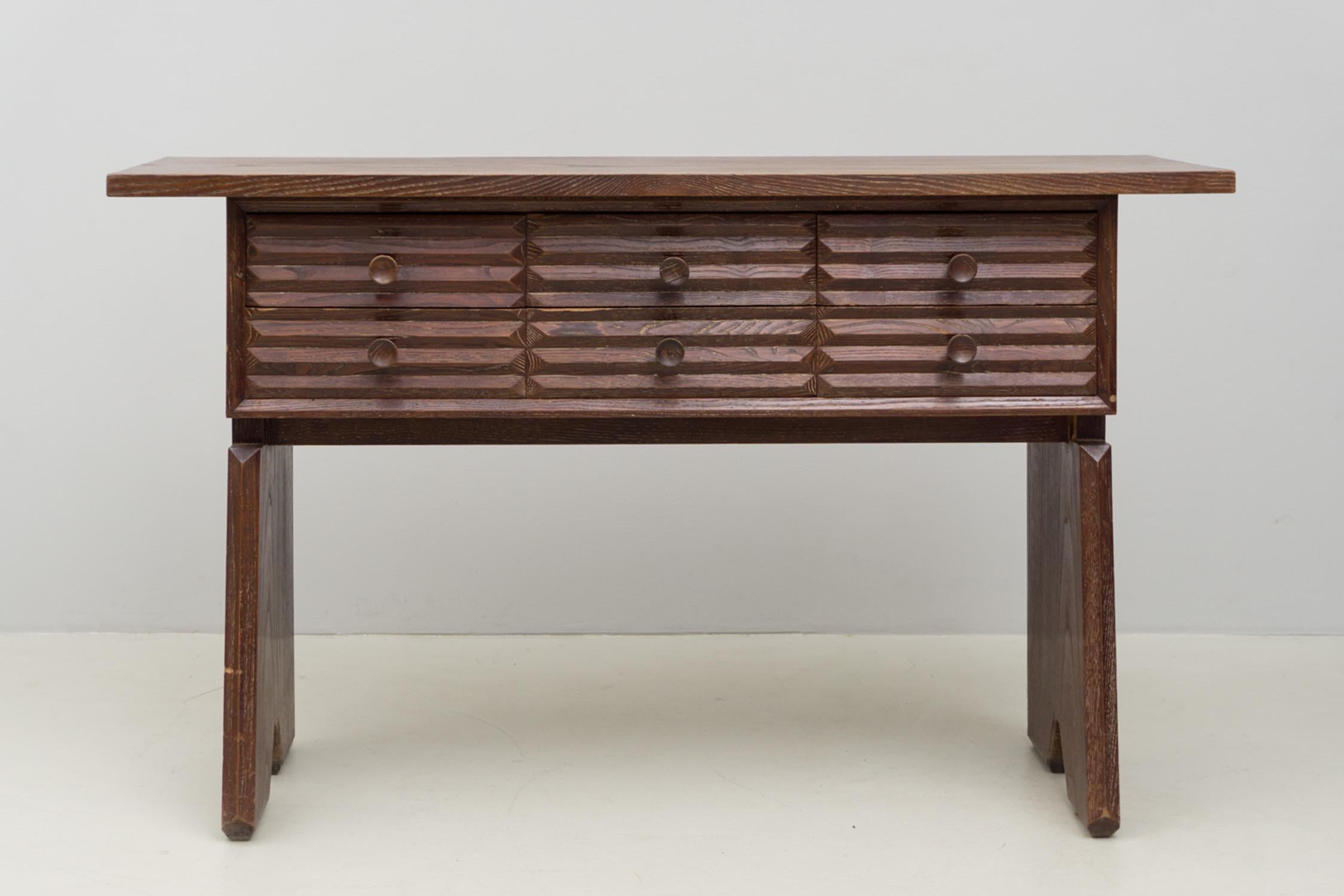 Rare and extravagant sideboard with drawers, made of stained solid wood. Six equally sized drawers with extraordinary surface design and round knobs, stable design of the sides.


