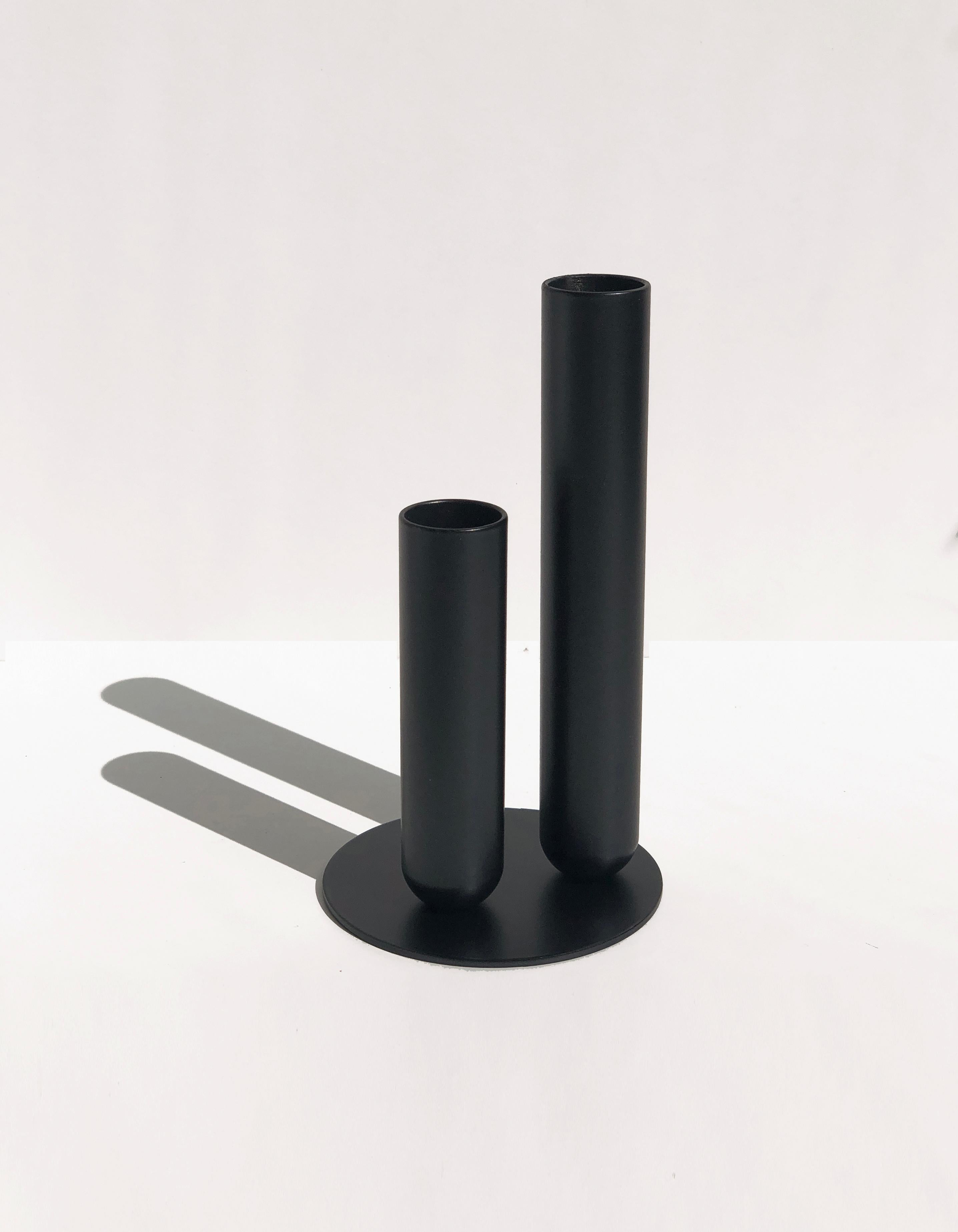 Soliflore Black Vase by Mademoiselle Jo
Dimensions: Ø 8.5 x H 15 cm.
Materials: Turned metal with magnet and EVA foam tray.

Hollow cylinders of 15 cm and 10 cm, diameter 2.5 cm. Plate diameter of 8.5 cm. Metal version with matt white or black