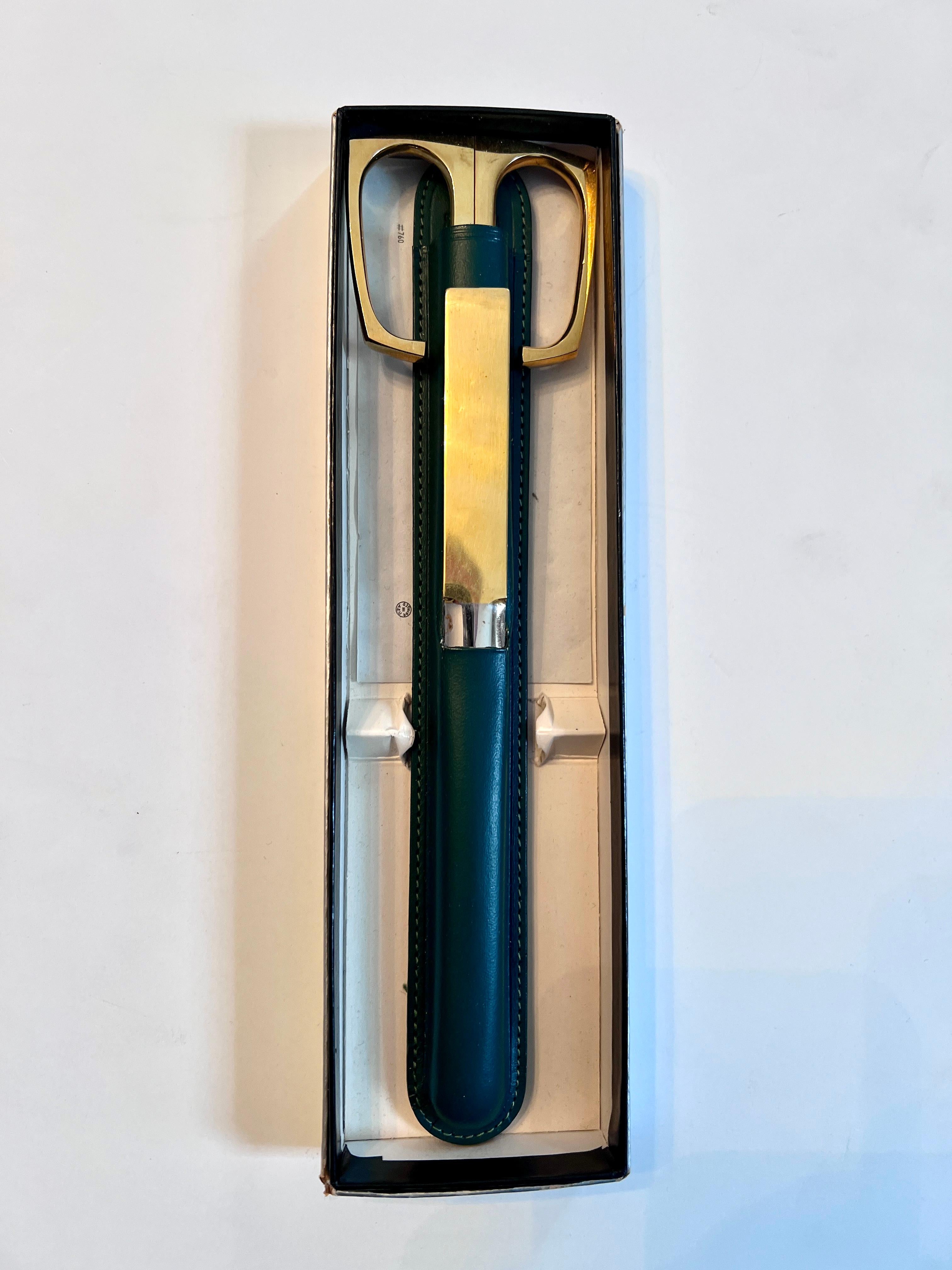 Italian-made hot-dropped forged steel plated in Nickel and Brass are used to make the scissors and letter opener. The green leather case is marked Solingen Germany. 


