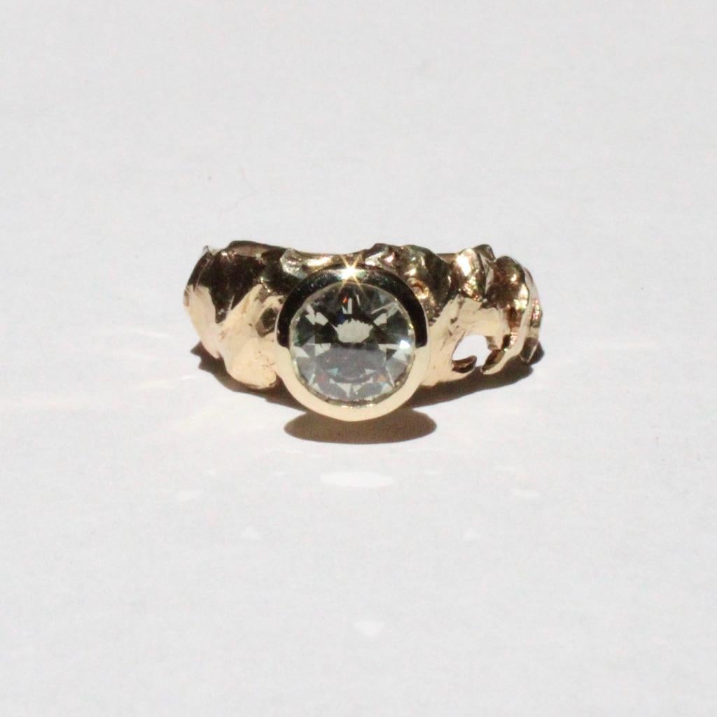 This gorgeous one of a kind hand carved diamond ring features a two carat grey diamond with report, bezel set in 14k gold. This piece is a statement with a unisex style, the upmost detail throughout and a style like none other. This is a size 8.25.