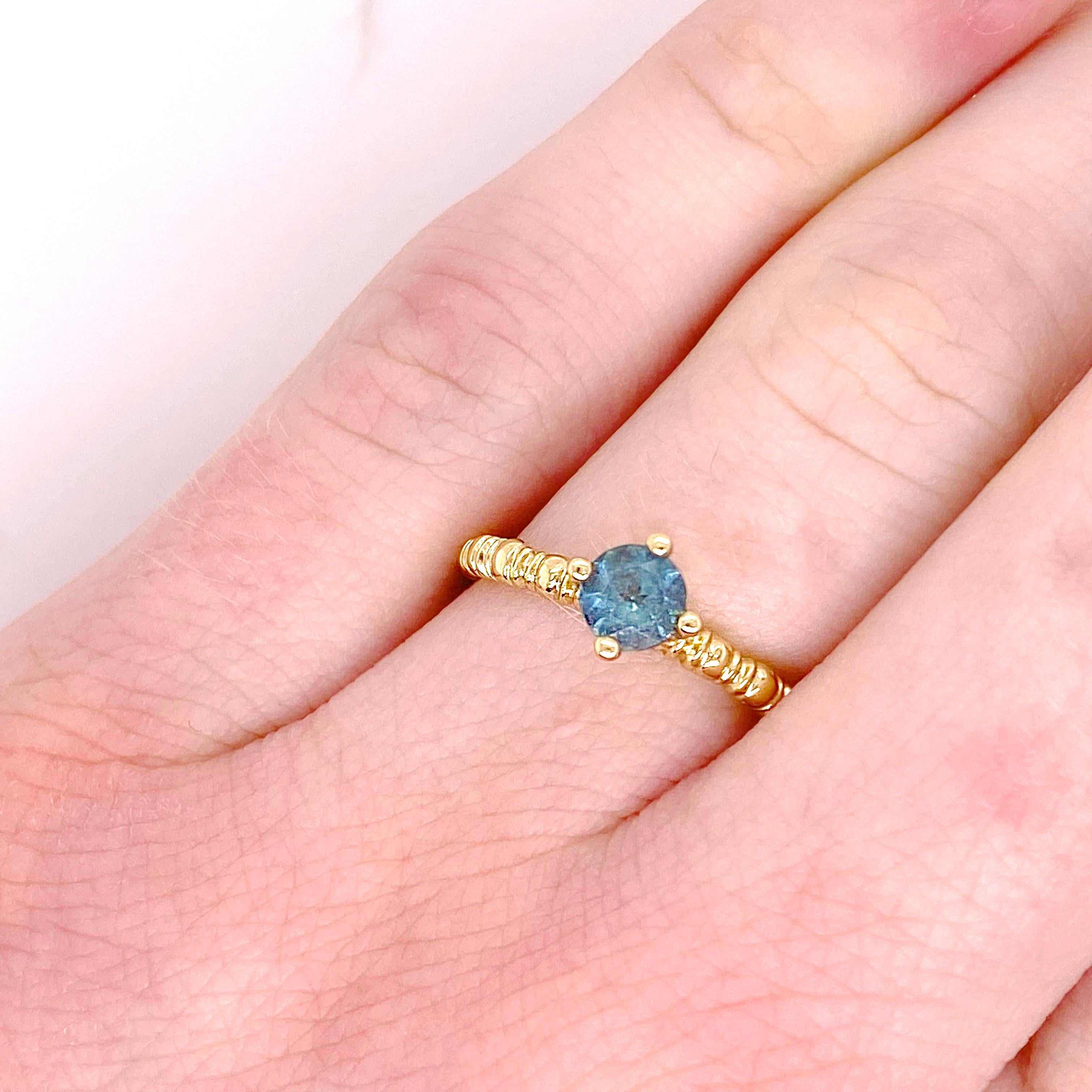The color combination of the vibrant turquoise blue apatite and the 14 karat yellow gold create such a fun design. Many people have not heard of apatite but its intensity of color makes it very popular with our clients! The textured band gives it