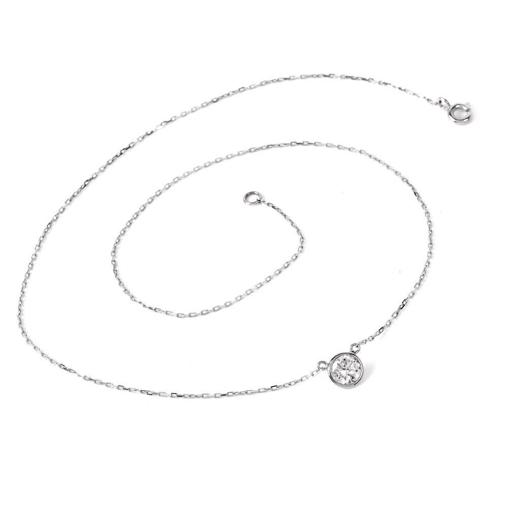 This simple Solitaire diamond by the yard necklace is crafted in solid 18k white gold. The necklace exposes 1 genuine round brilliant cut diamond of approx: 0.74 carats, H-I Color, VS2 Clarity, Bezel set. This item features a charming chain with a