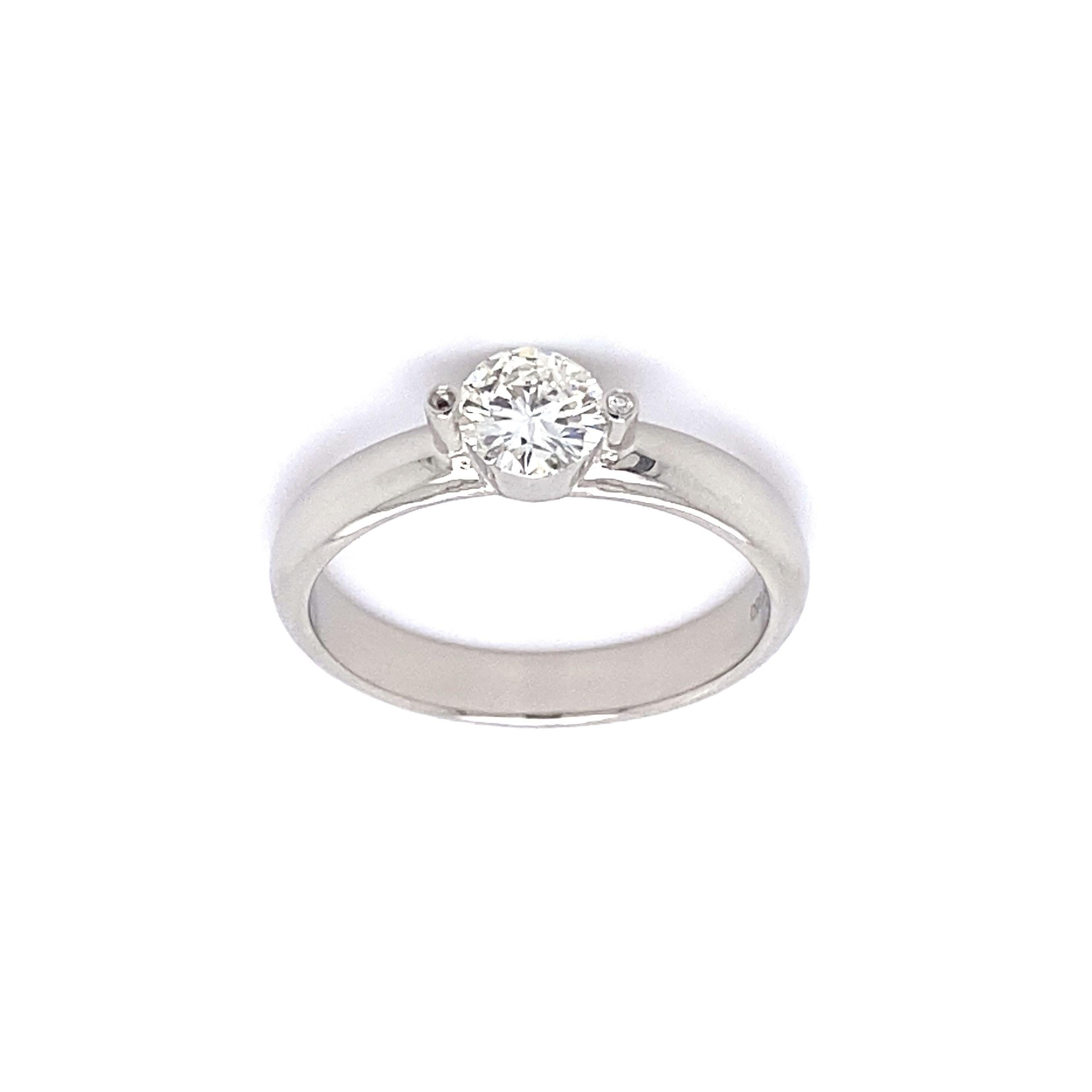 Designer Gumuchian Solitaire Diamond Platinum Ring, securely nestled with a Hand set Round Brilliant Cut Diamond weighing approx. 0.52 Carat, H/I color, I1 clarity, accented by side Diamonds. Hand crafted in Platinum. Measuring approx. 0.89” L x