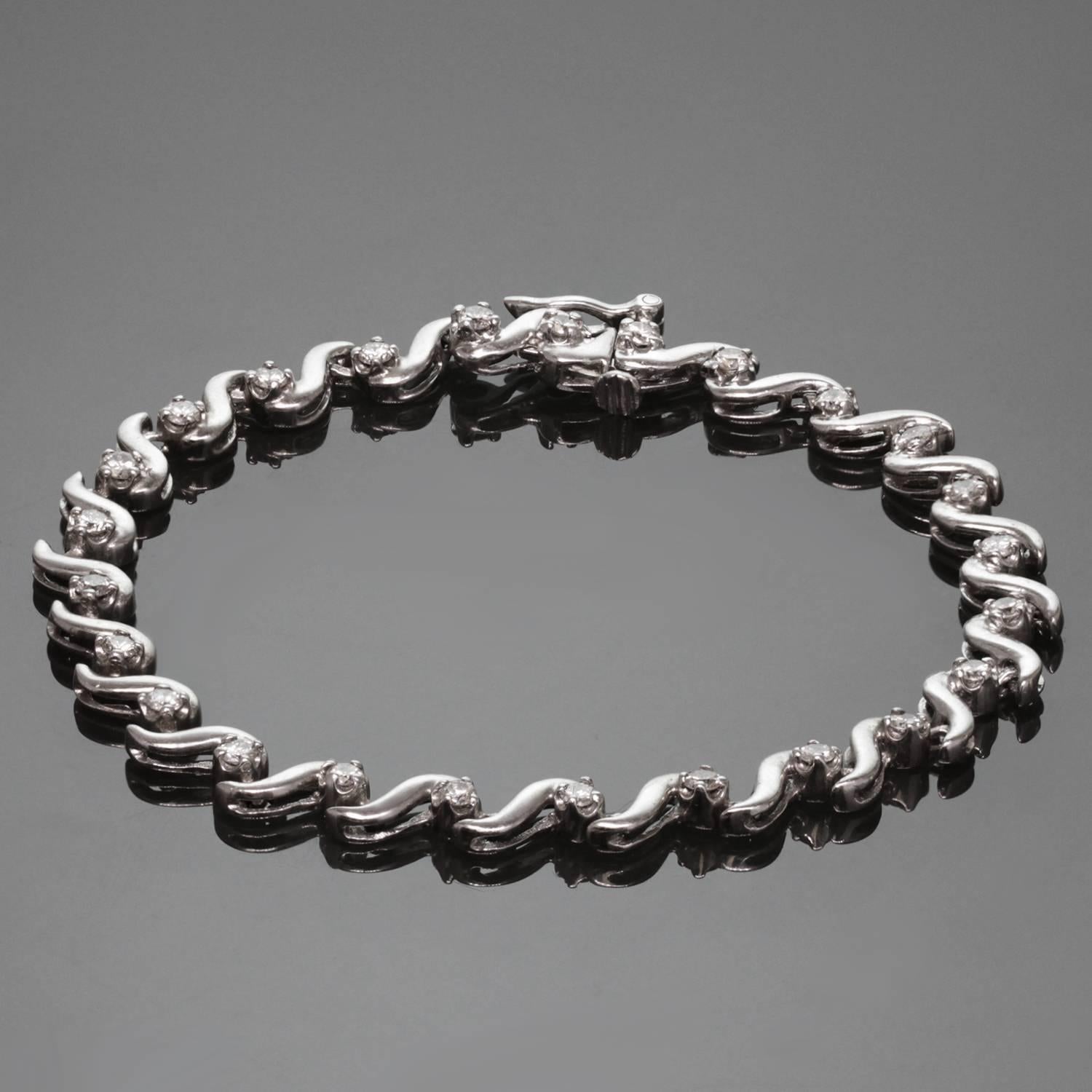 A classic modern tennis bracelet featuring 14k white gold wavy links prong-set with 24 solitaire round diamonds of an estimated 1.40 carats. A timeless design for everyday elegance. Measurements: 0.19