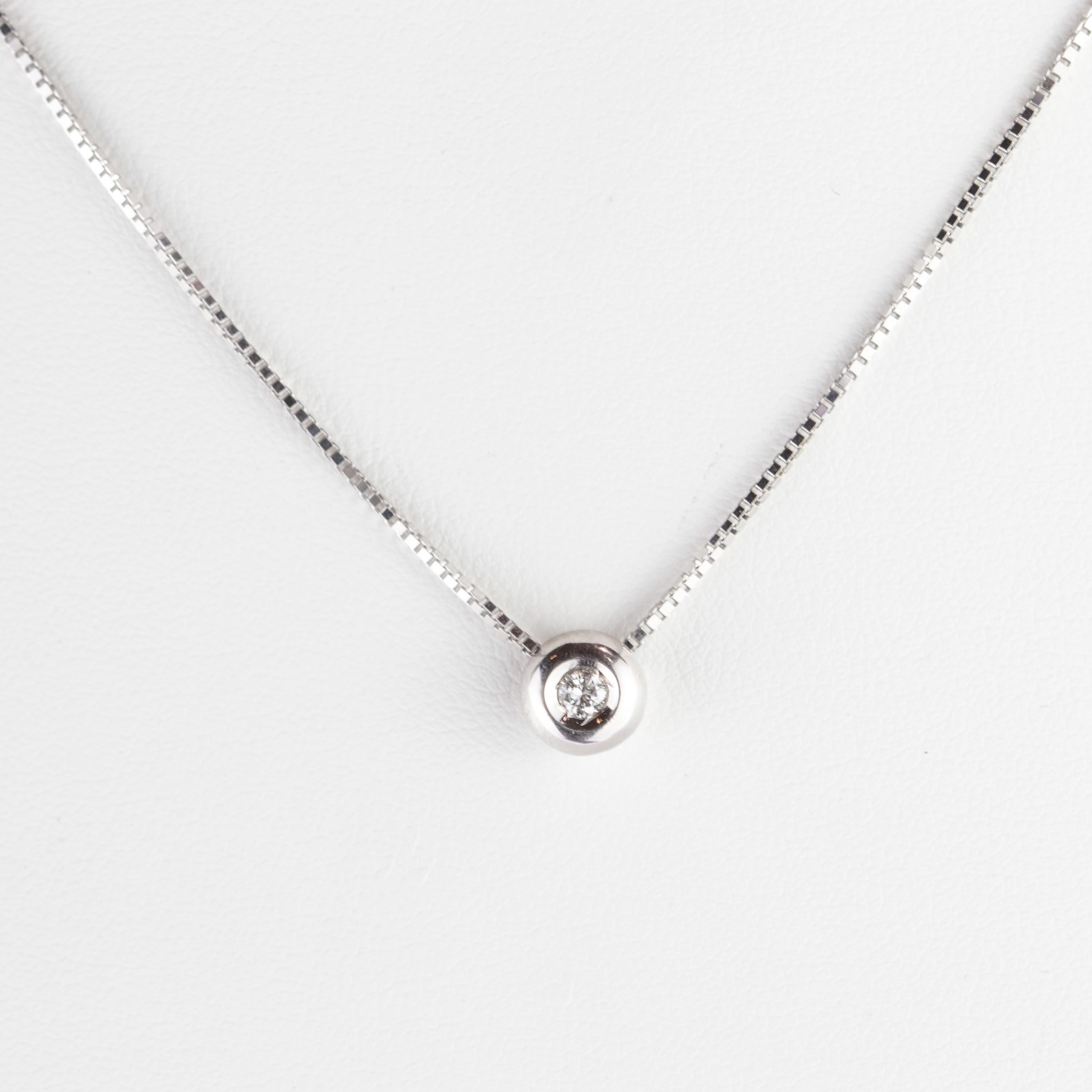 Solitaire diamond brilliant cut halo pendant surrounded by 18 karat white gold circle and holded into a white gold chain Necklace. With 0.2carat the gem highlights with a simple but bright look. Is the perfect and stylish accessory to represent a