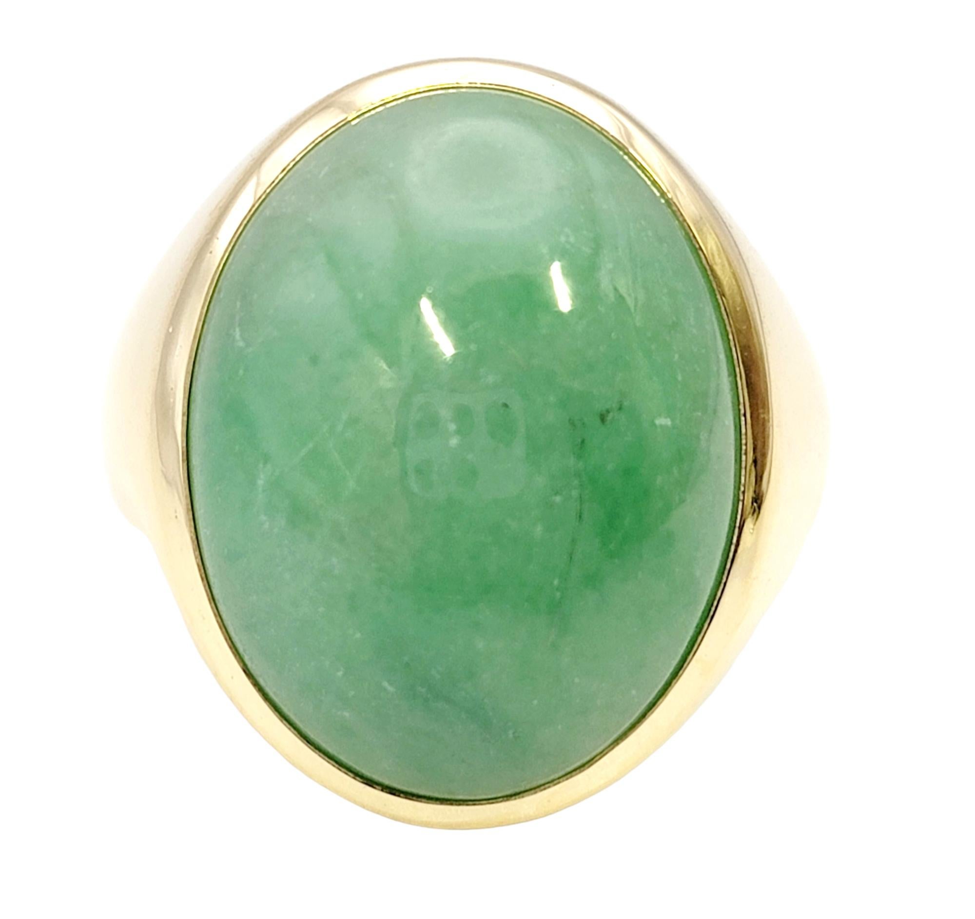 Ring size: 10

Featured here is a sophisticated Jadeite cocktail ring, a true statement of elegance and luxury. Meticulously crafted in luminous 14K yellow gold, this ring showcases a mesmerizing oval jadeite cabochon that exudes a captivating