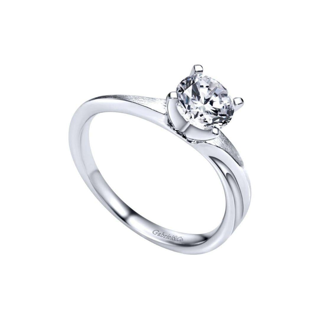 Ladies' Solitaire 14k White Gold Diamond Engagement Mounting. A slightly curved shank with a satin finish and a gentle groove add a modern romance twist on this traditional Tiffany style setting. Center diamond NOT included.