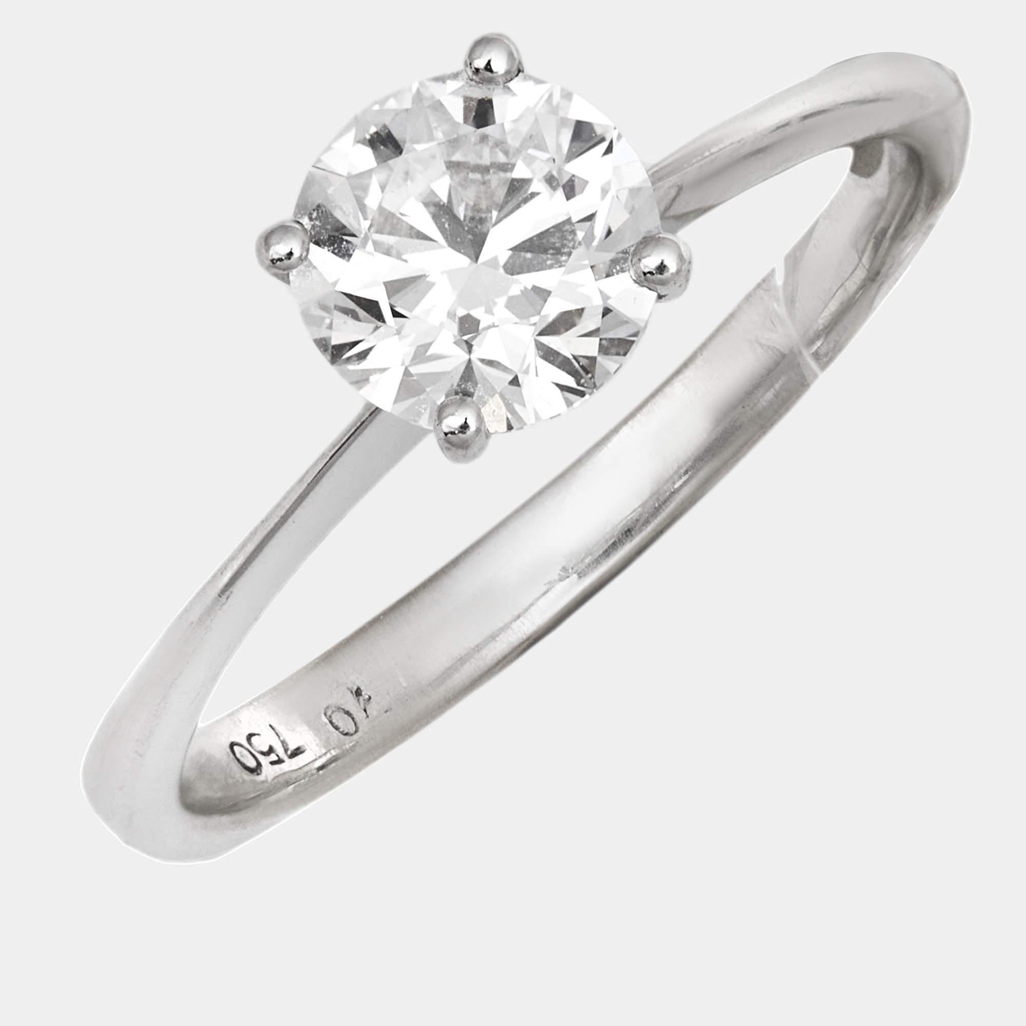 Crafted with precision this wedding ring dazzles featuring a harmonious assembly of a solitaire set in lustrous 18k white gold. Its timeless design combines luxury with a modern twist perfect for those who appreciate refined aesthetics and a touch