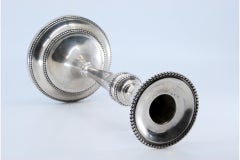 Solitary candlestick in smooth silver w/ friezes on the shaft & circular base