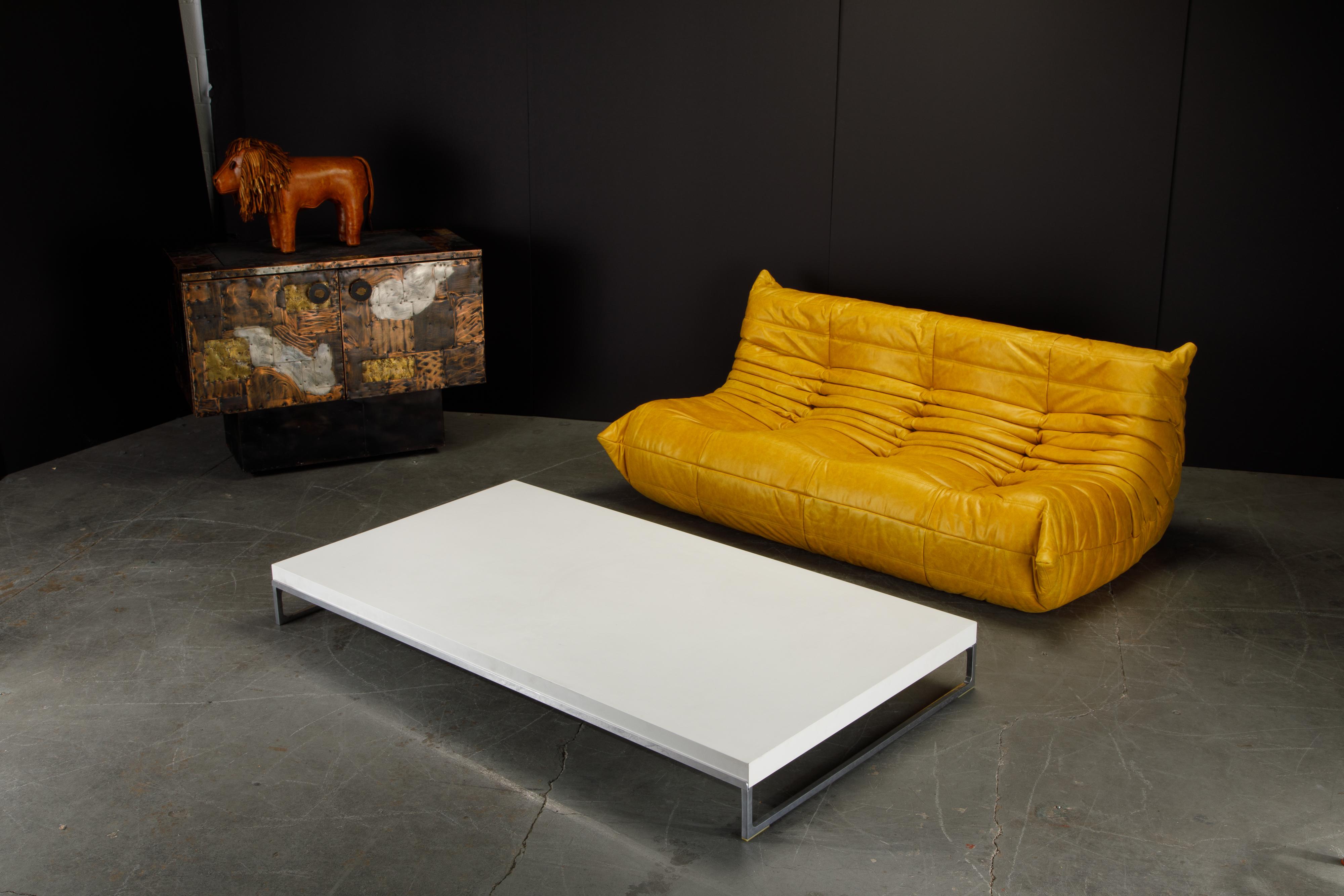 This sleek minimalist 'Solo' cocktail table by Antonio Citterio for B&B Italia features a matte lacquered white wood top over modern aluminum legs. 

This 'Solo' low table by Antonio Citerrio for B&B Italia would work great in a Contemporary or