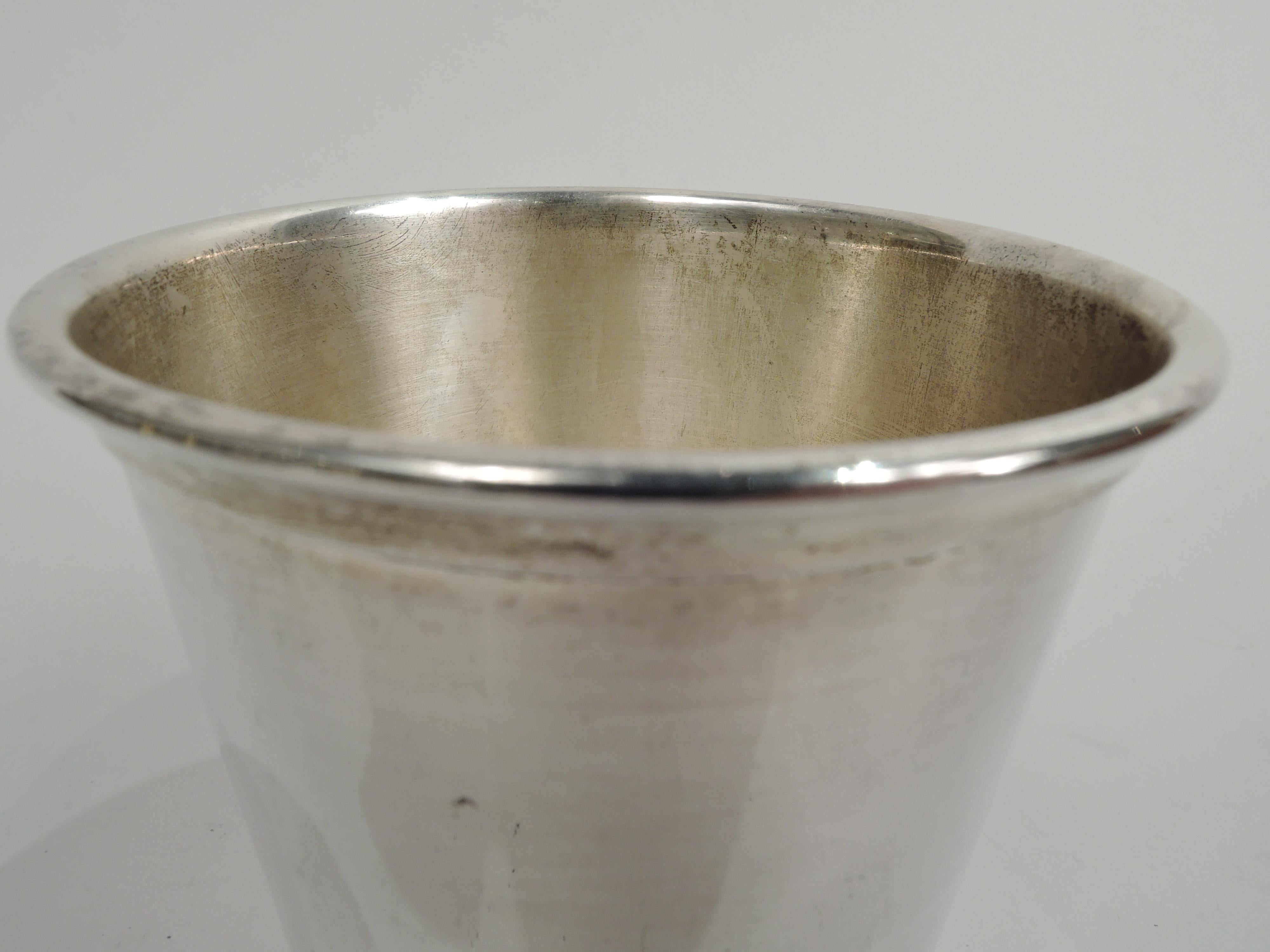 Solo sterling silver mint julep cup. Made by Webster Co. in North Attleboro, Mass. Straight and tapering sides, and molded rim. A great home-alone accessory. Fully marked including maker’s stamp and no. 8555. Weight: 3.4 troy ounces.