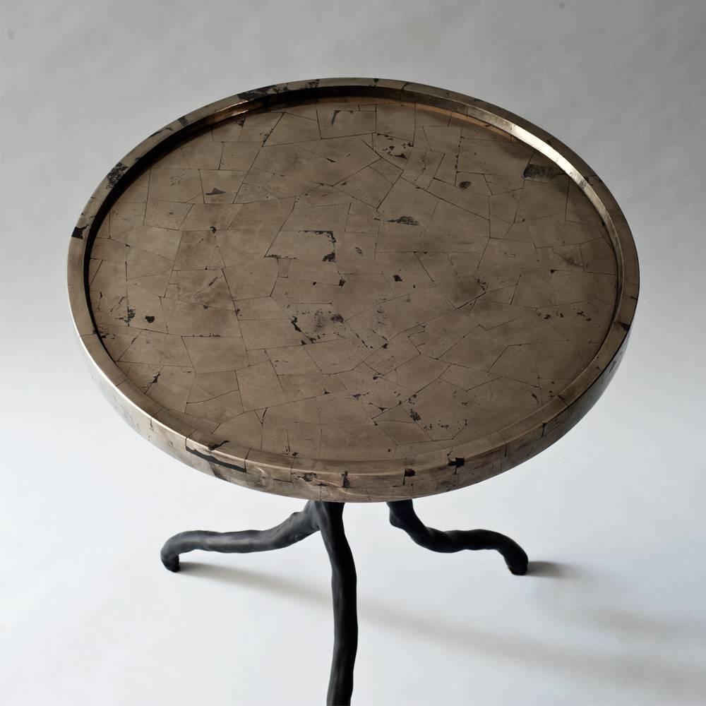 The Solstice side or end table by DeMuro Das has a tray top in Golden Pyrite, a mineral also known as 