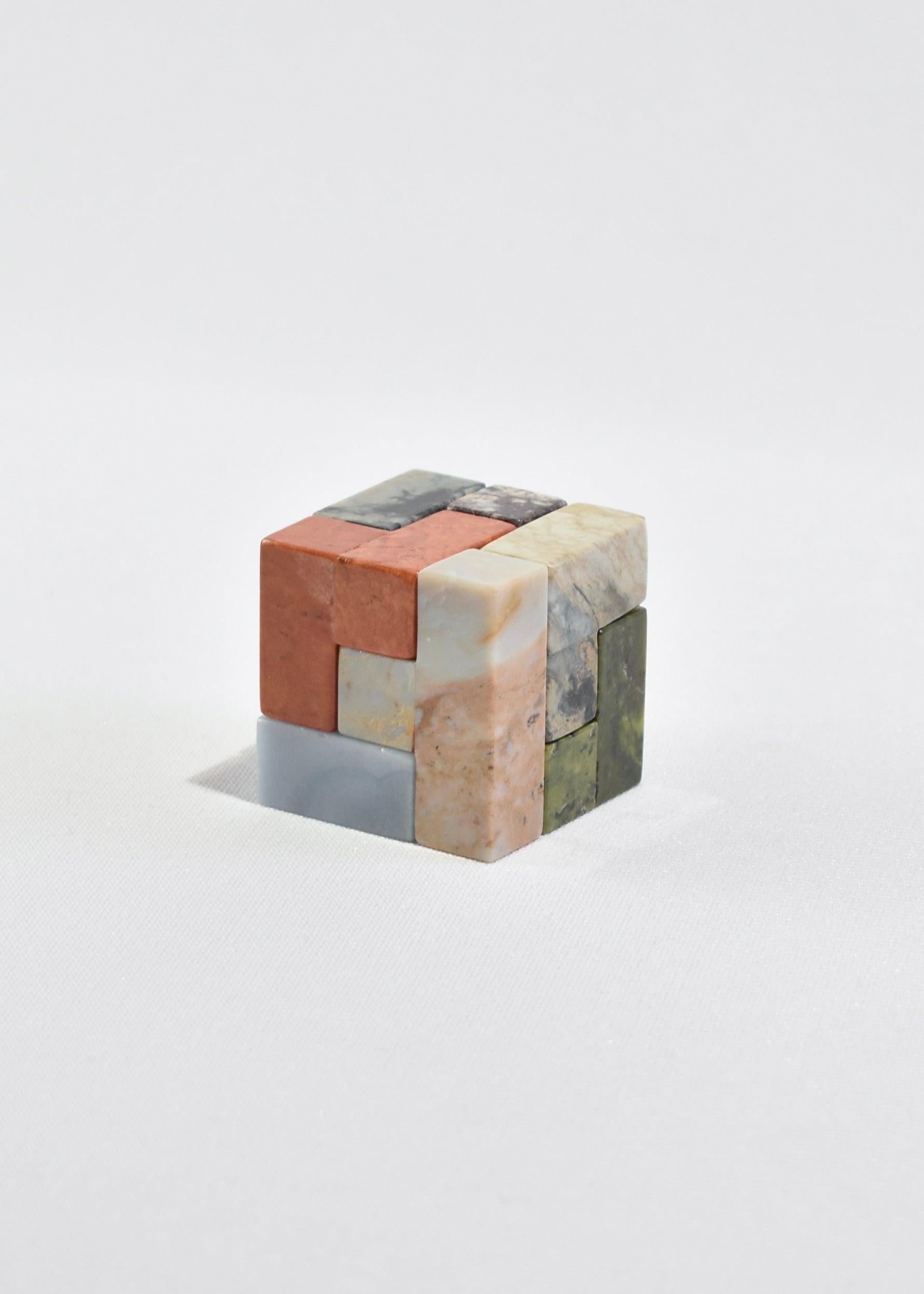 Hand-carved soma cube puzzle sculpture in a mix of 7 brightly colored semi-precious stones that form a perfect square (with 32 ways to solve). A beautiful coffee table piece or sculptural object when not in use and the perfect gift for architects,