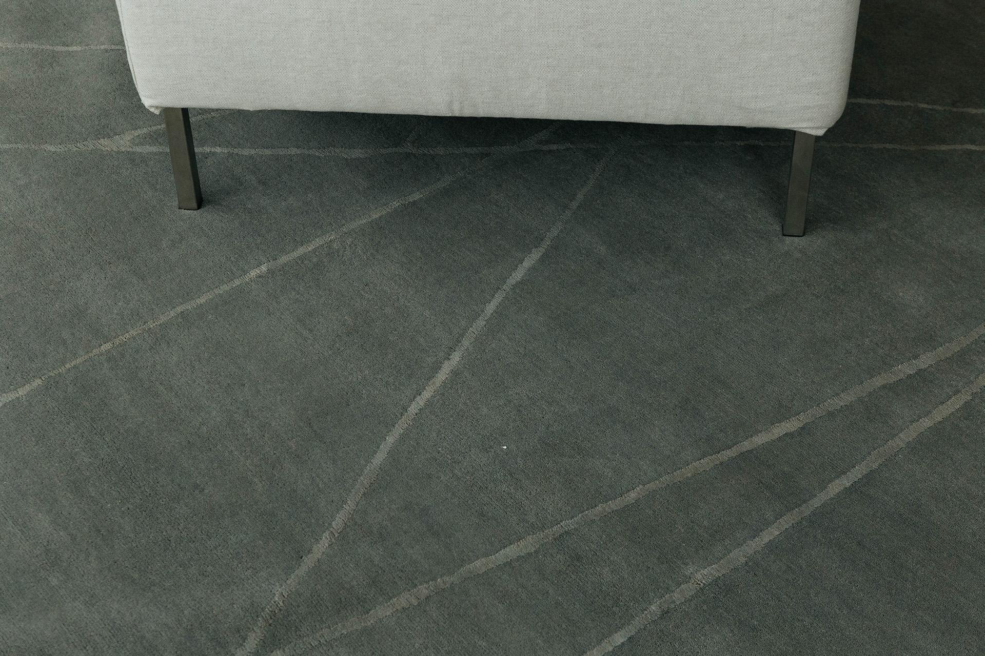 Some Time Soon' is a handwoven modern abstract rug made of wool and silk. It is a part of our design Rhymes collection which pulls inspiration from different aspects of architecture. The thin gray linework moving across the rug creates a wide space