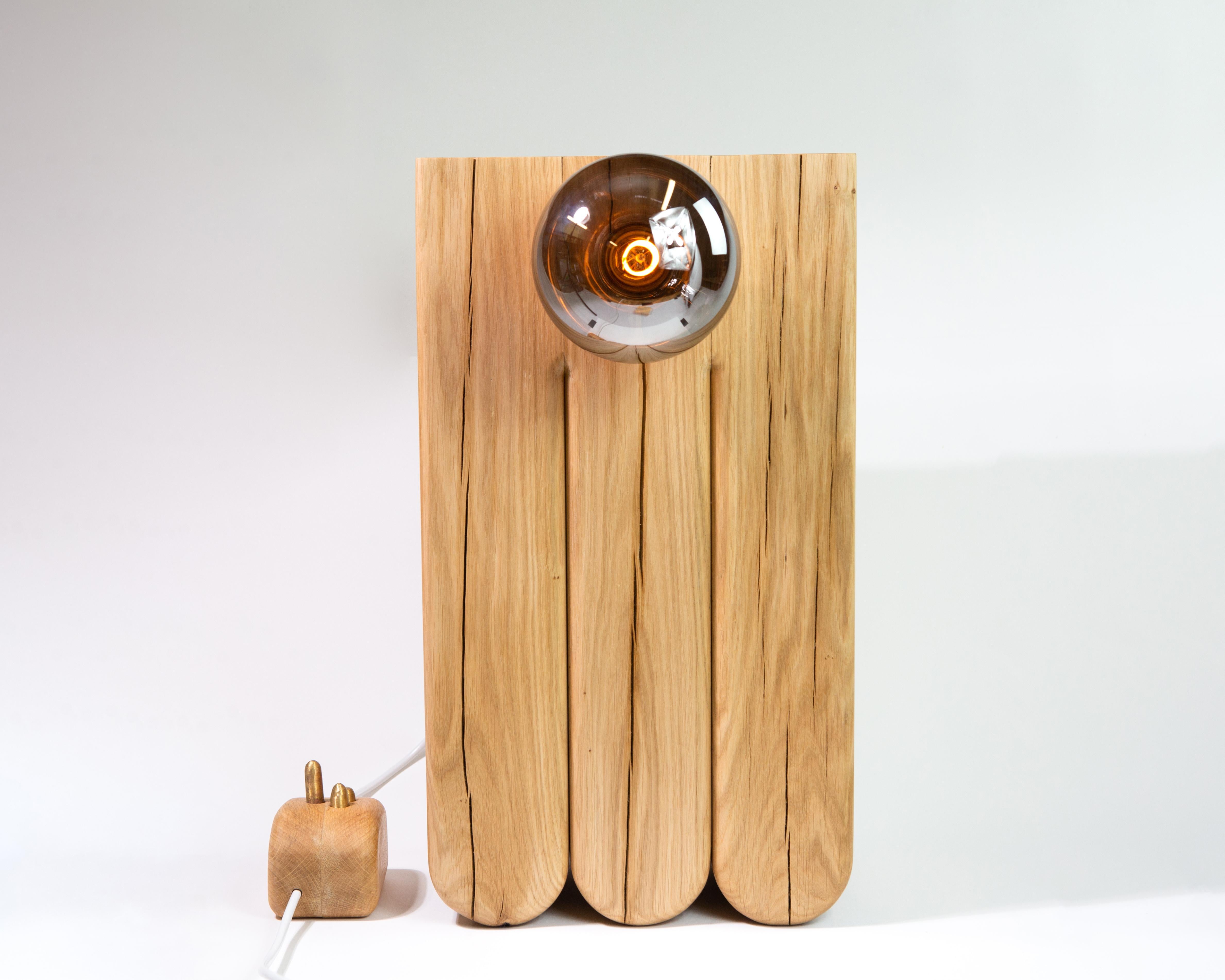 Touch Sensitive Lamp. Solid oak body and appendage with brass cilia.