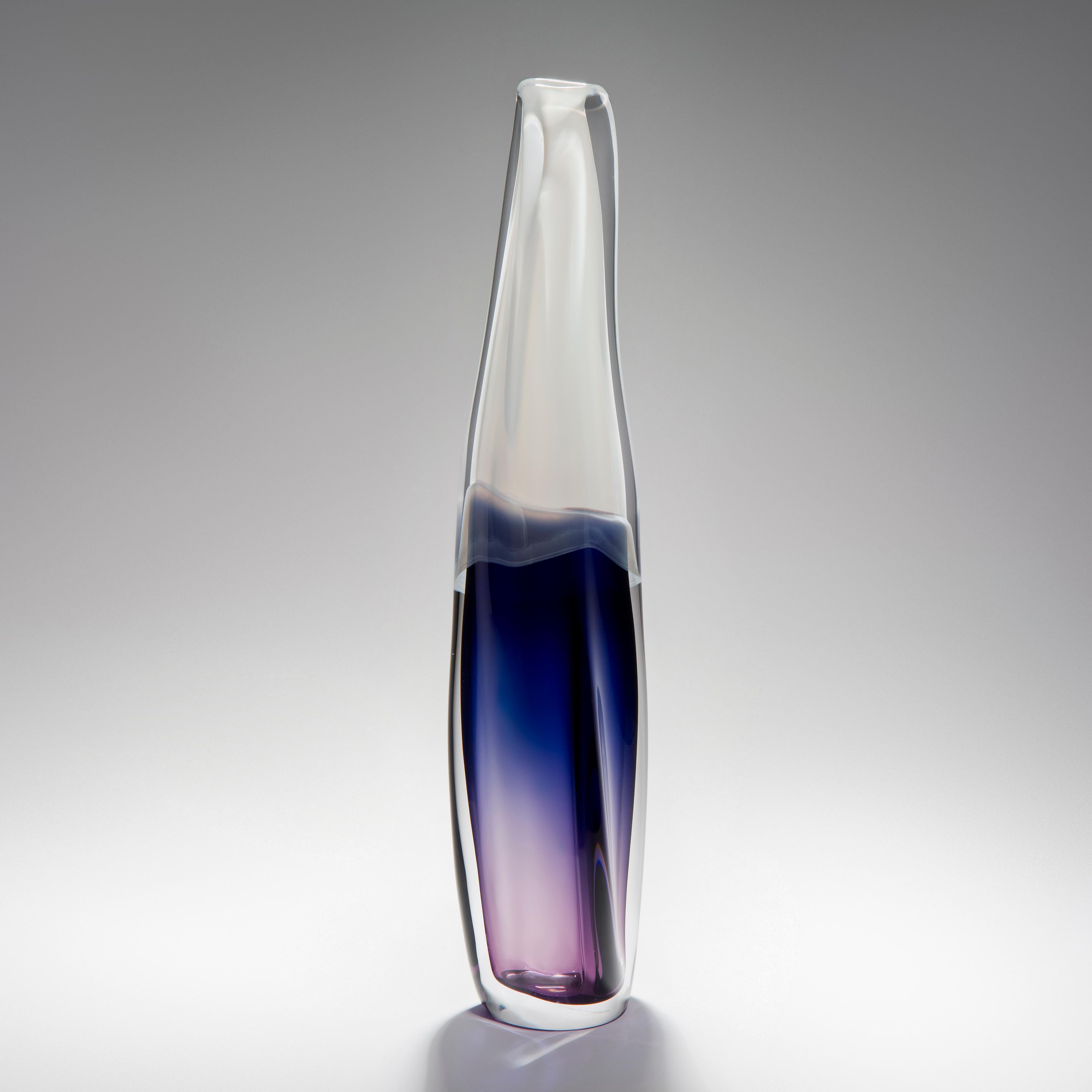 Sommercalmo 138 is a unique hand blown sculptural vase by the British artist Vic Bamforth. Soft opaque white and mesmerising deep purple meet and are encased in clear glass to create this stunning piece. With soft, twisting lines, the form has