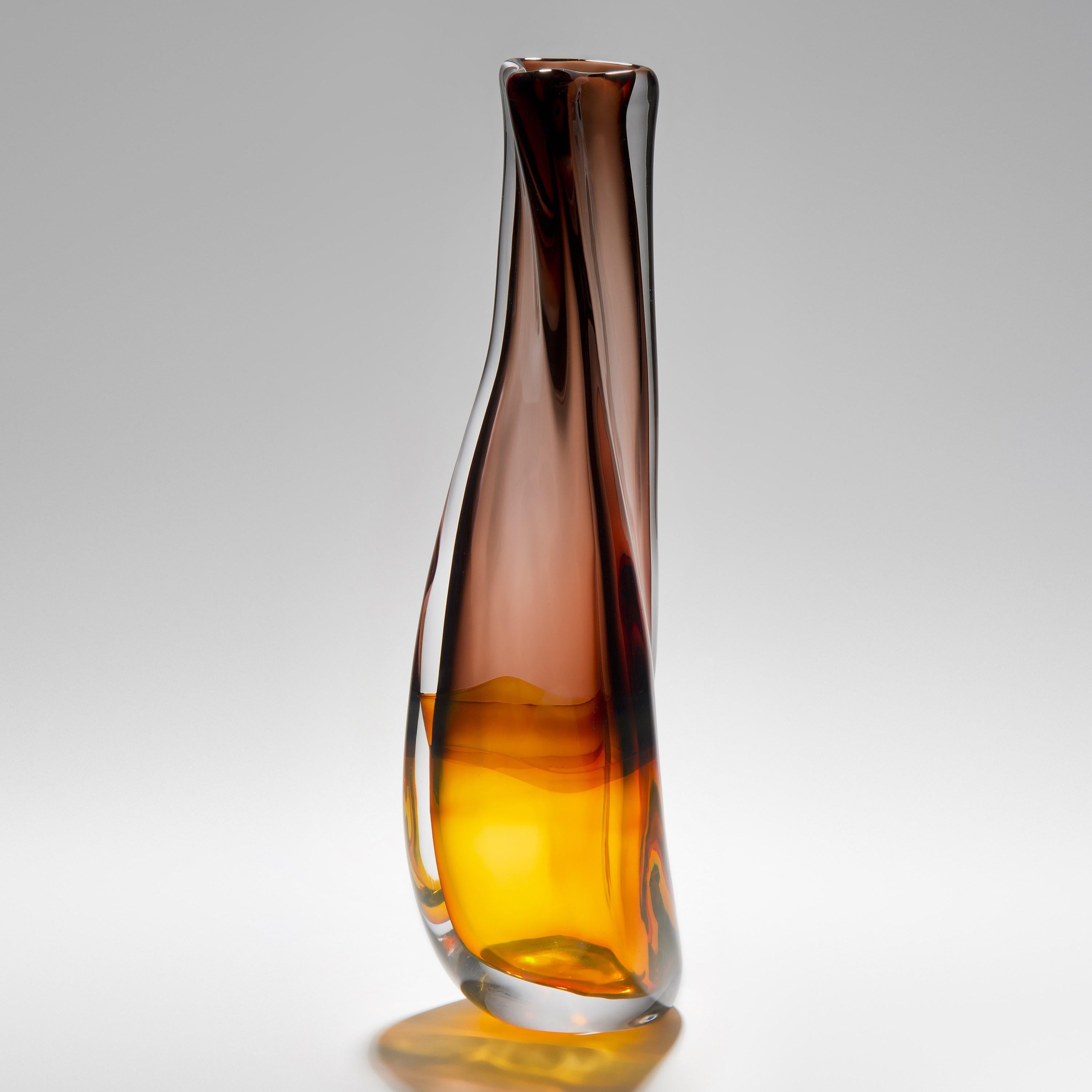 'Sommercalmo 82' is a unique hand blown sculptural vase by the British artist Vic Bamforth. Golden amber and warm brown meet and are encased in clear glass to create this stunning piece. With soft, twisting lines, the form has dynamic movement,