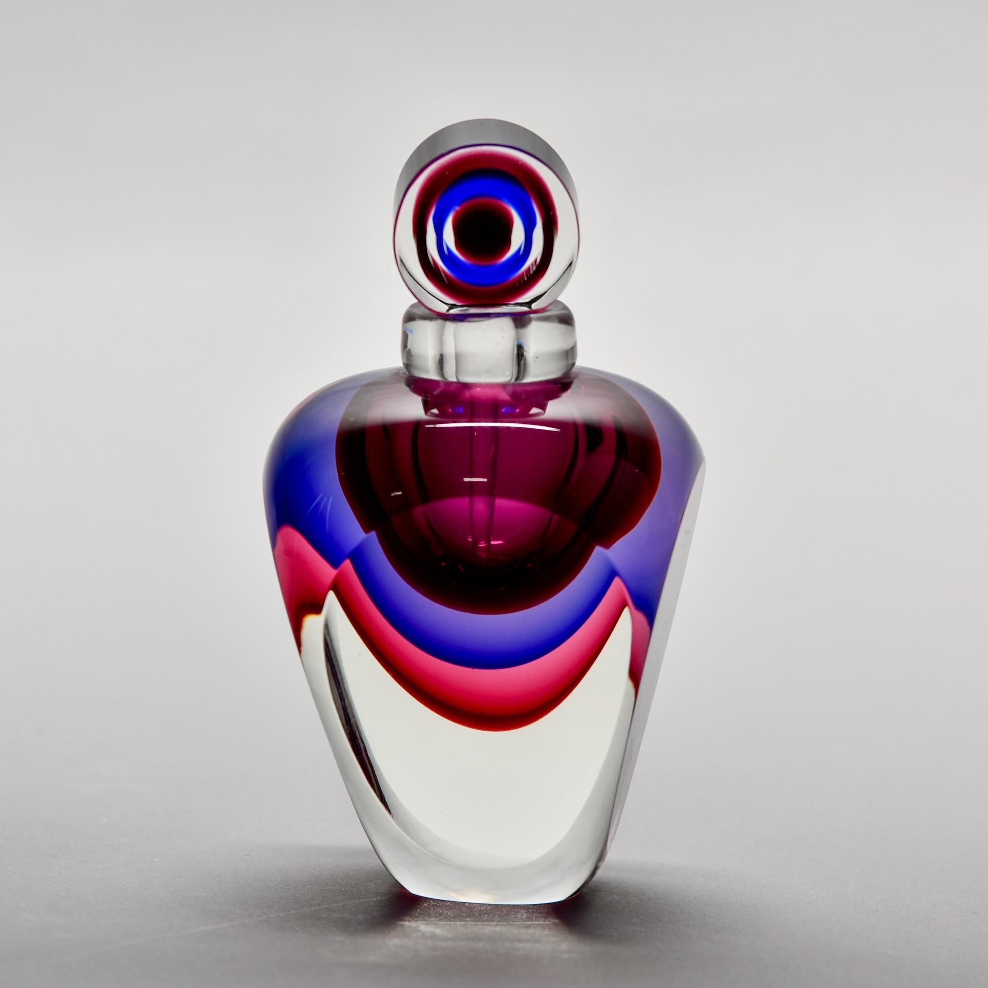 Found in Italy, this sommerso style Murano glass perfume bottle features heavy, clear glass with layers of fuchsia, violet and garnet in the vessel and stopper. Unsigned. New, with no flaws found.